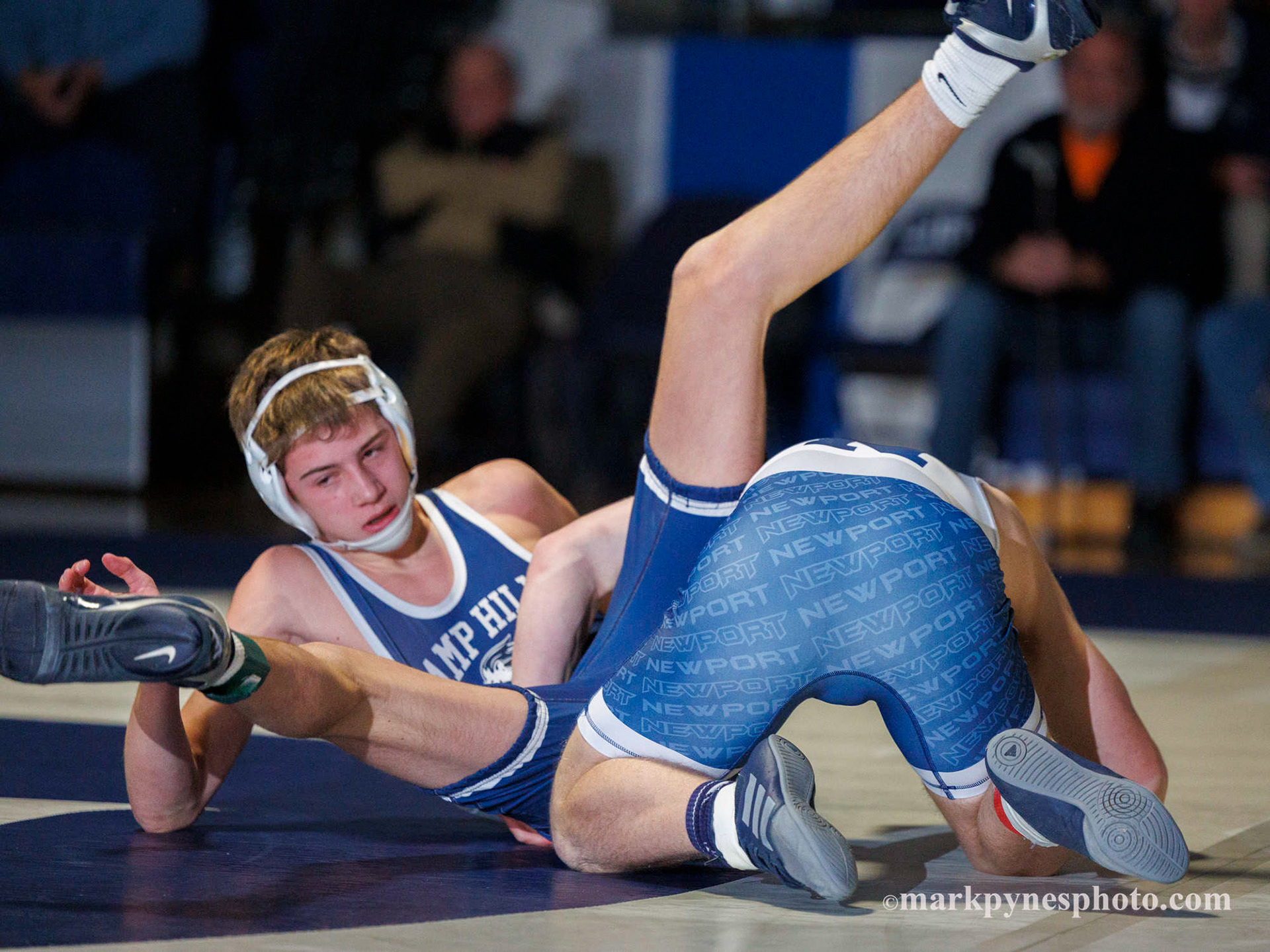 Camp Hill’s Foster Wolgemuth is thrown by Newport’s Marek Polcha, on the way to a tech fall at 121 pounds.