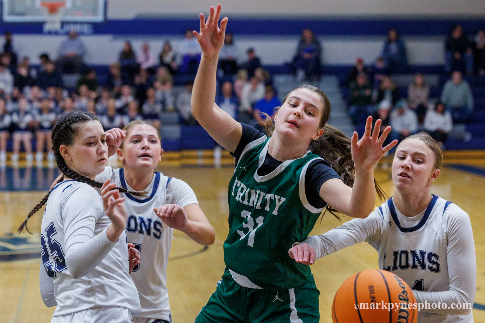 Aryana McCleary, Trinity, loses a rebound as Camp Hill defenders Kyla Sanderson, Natalie Knuckle and Camden Werley look on and Trinity wins, 61-16, in Camp Hill, Pa., Dec. 9, 2025.