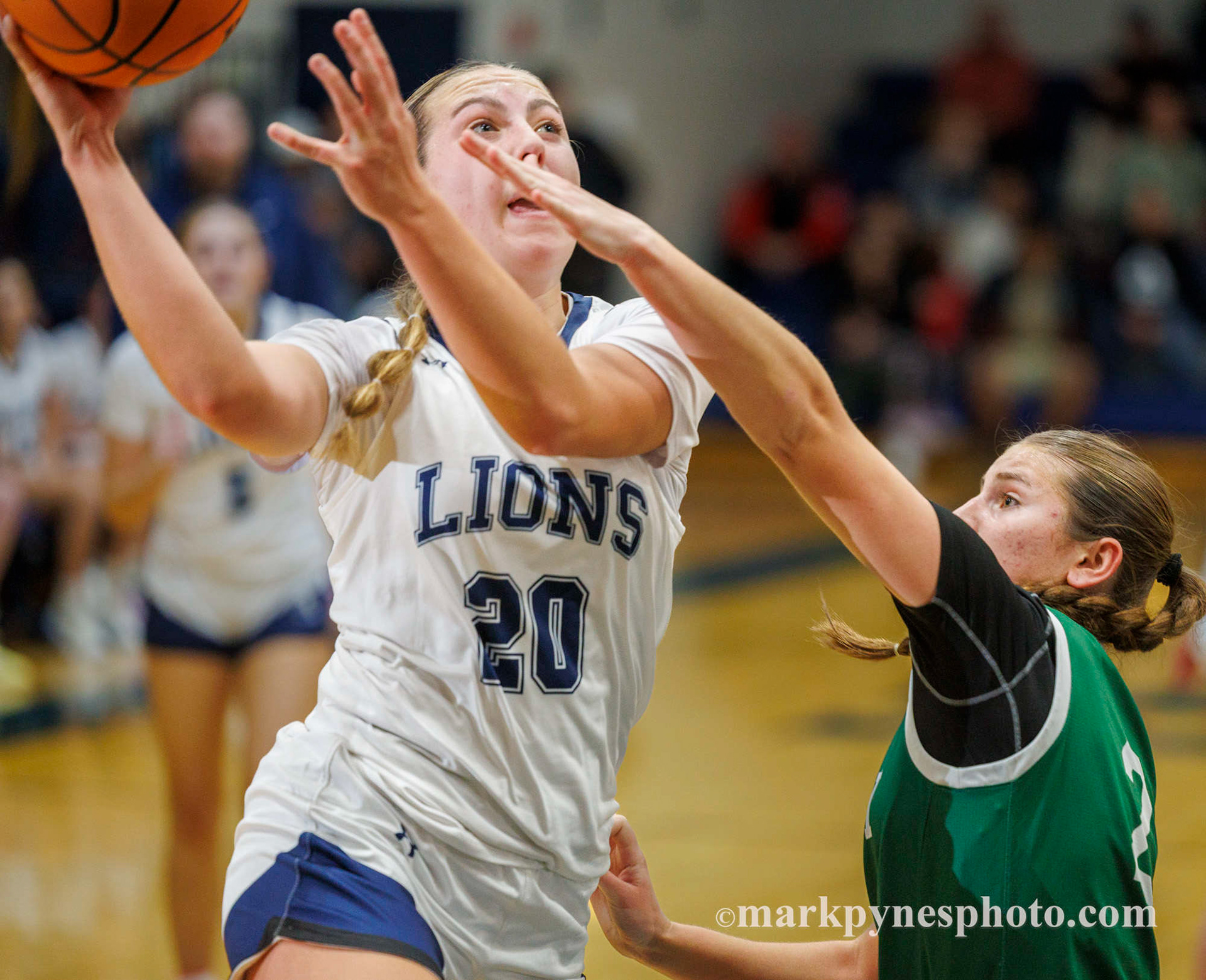 Lindsay Johnson drives on Trinity’s Emma Kostelac, but Trinity wins, 61-16.