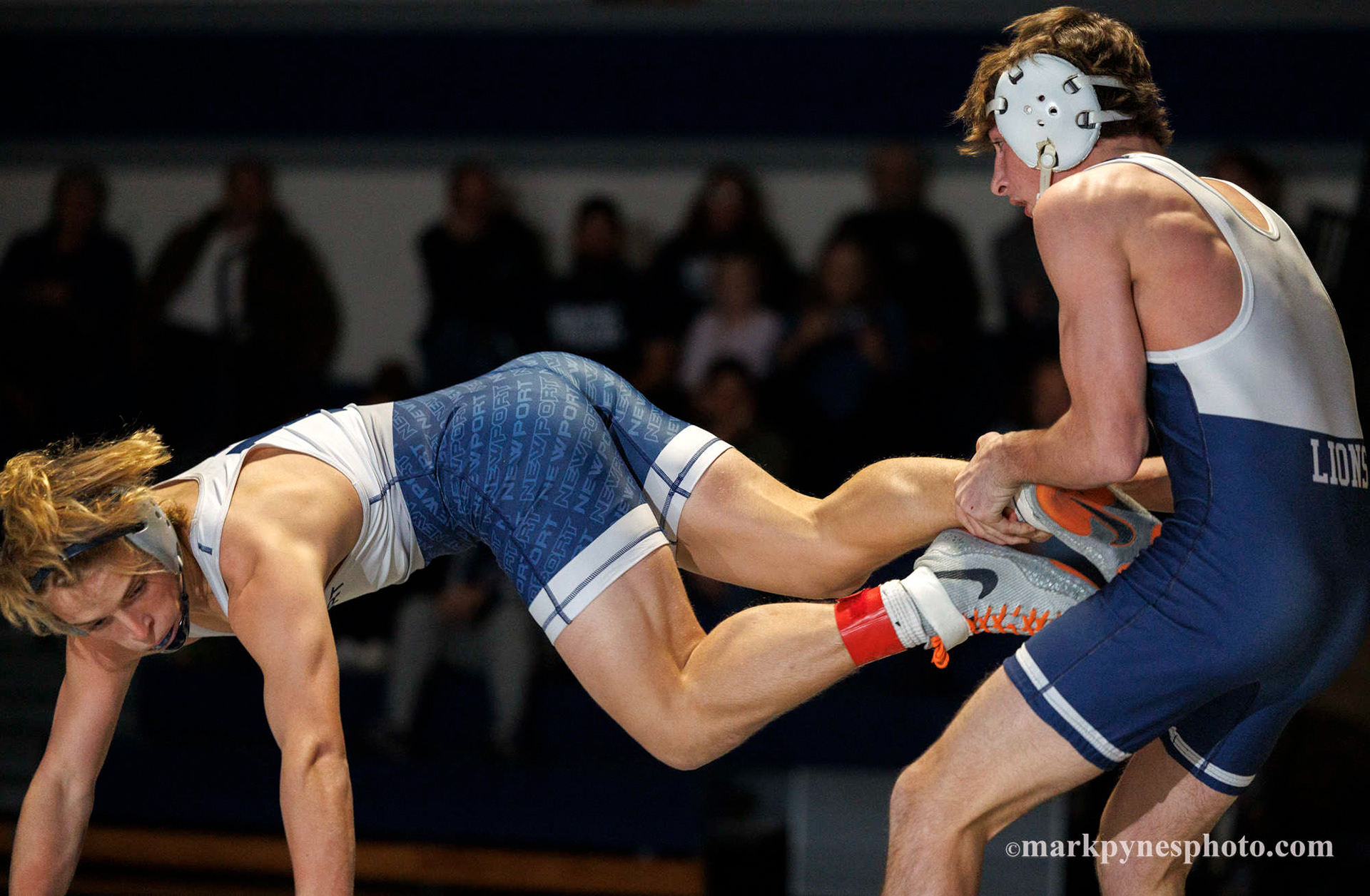 Sam Miller, Camp Hill, grabs Newport’s Chris Imler, in the 133 pound match, won by Imler in overtime.