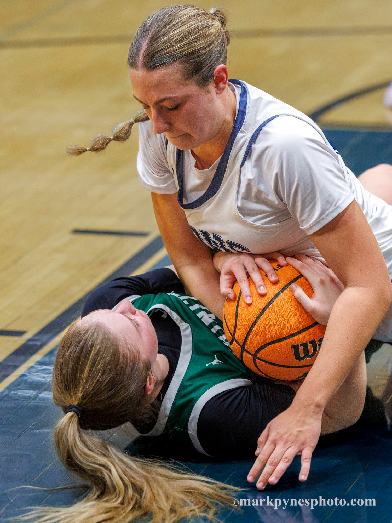Bella Jones and Lindsay Johnson fight for a loose ball as Trinity defeats Camp Hill, 61-16, under a withering first half full-court press and 25 points by 21, in Camp Hill, Pa., Dec. 9, 2025.