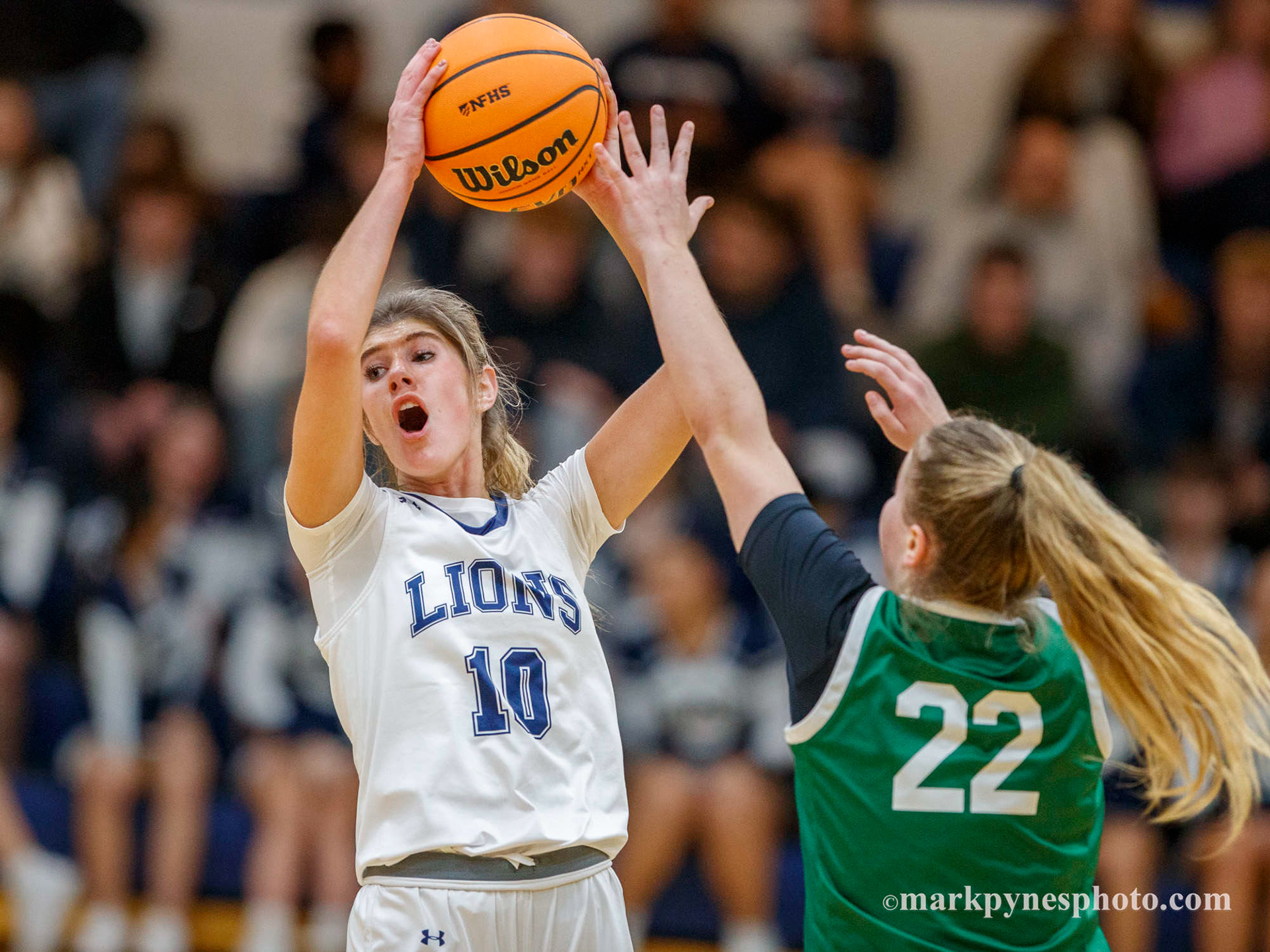 Elle Shover calls out for help on pressure from Trinity defender Bella Jones.