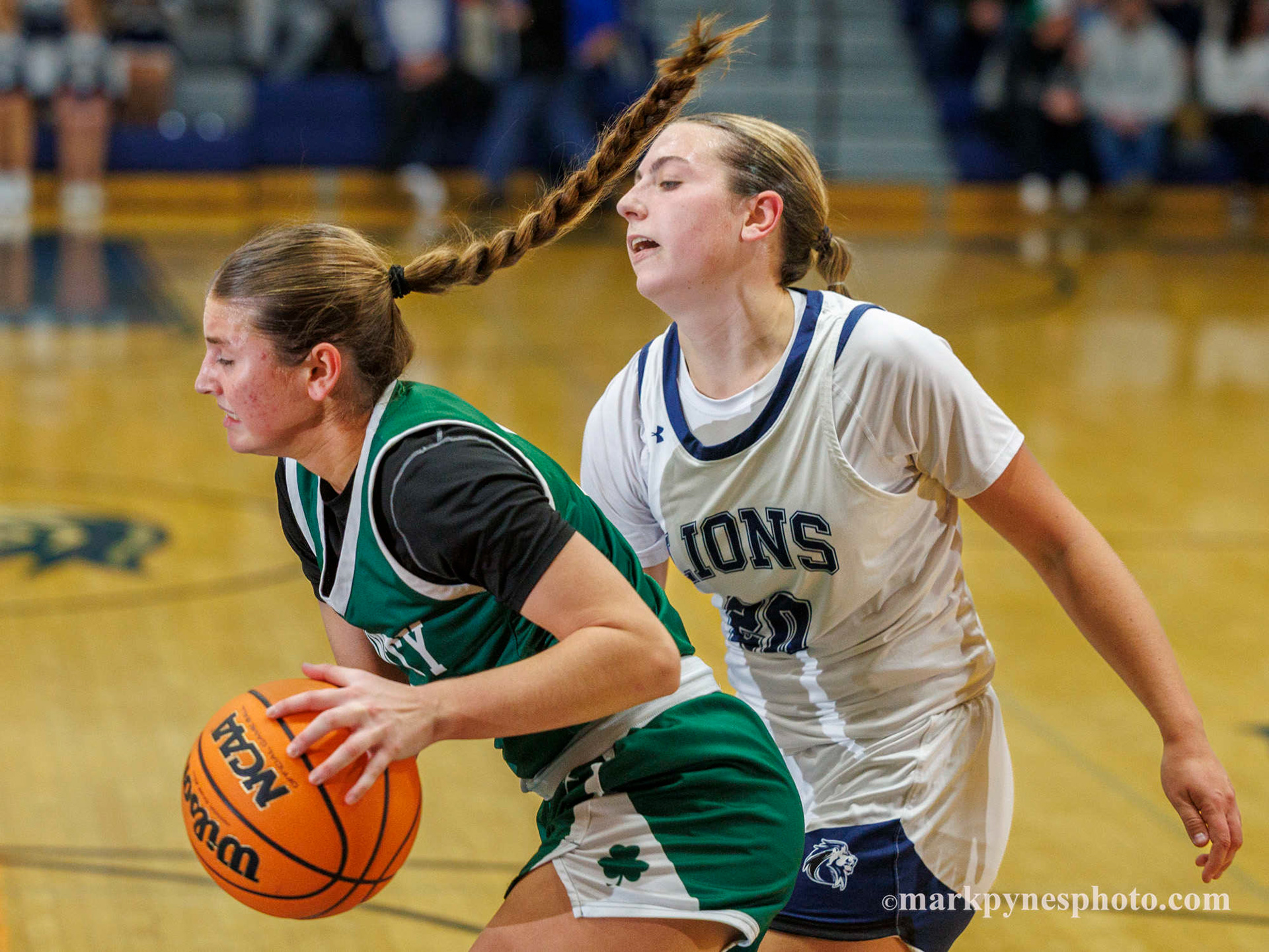 Emma Kostelac, Trinity, grabs a rebound from Lindsay Johnson as Trinity wins, 61-16