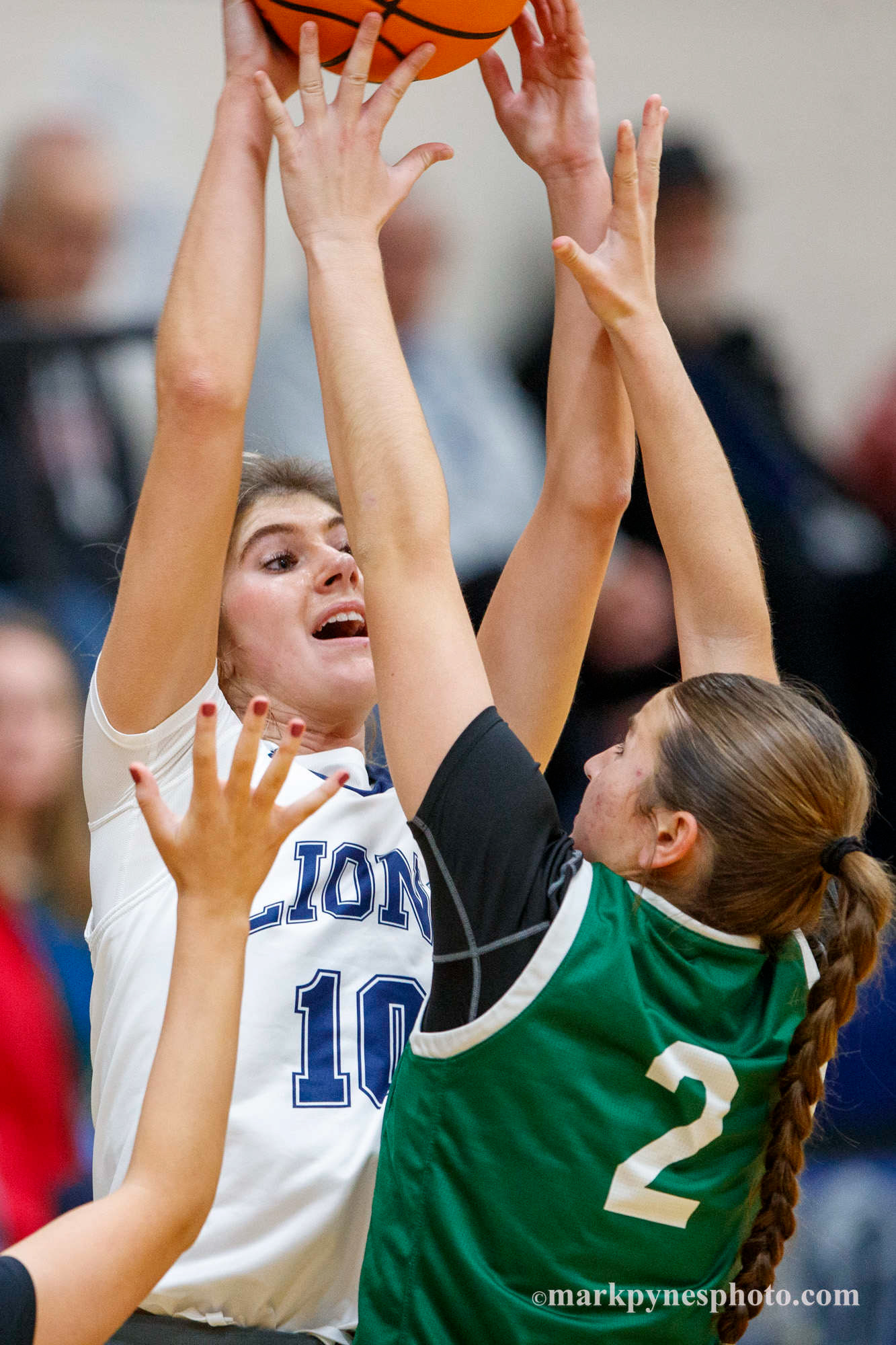 Elle Shover passes over Trinity’s Emma Kostelac.