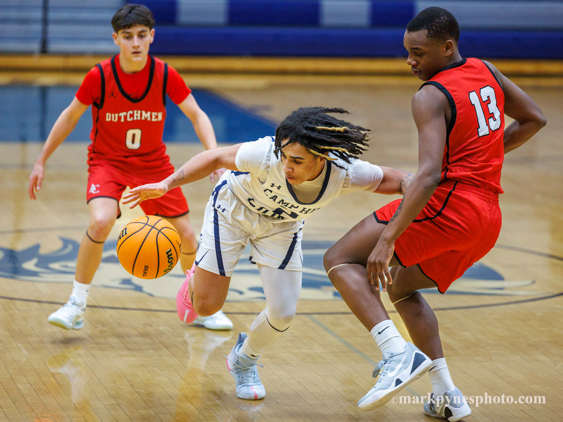 Camp Hill’s Nate Ransom scrambles up court with the ball between Annville-Cleona defenders John Ditzler and Zari Hogue.