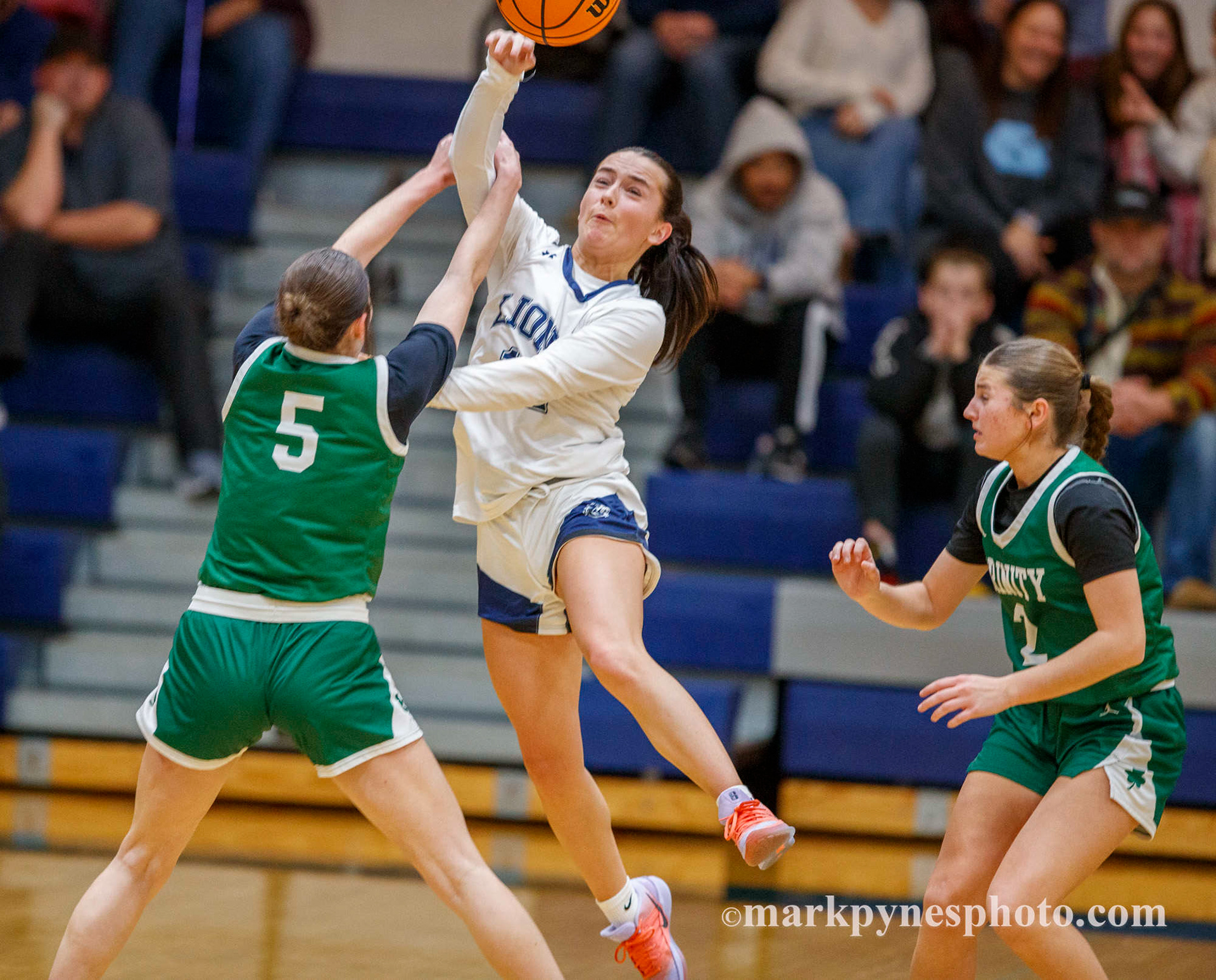 Cecilia Battisti tries to break a hard full-court press by Trinity’s Ashley Berkheimer and Emma Kostelac.