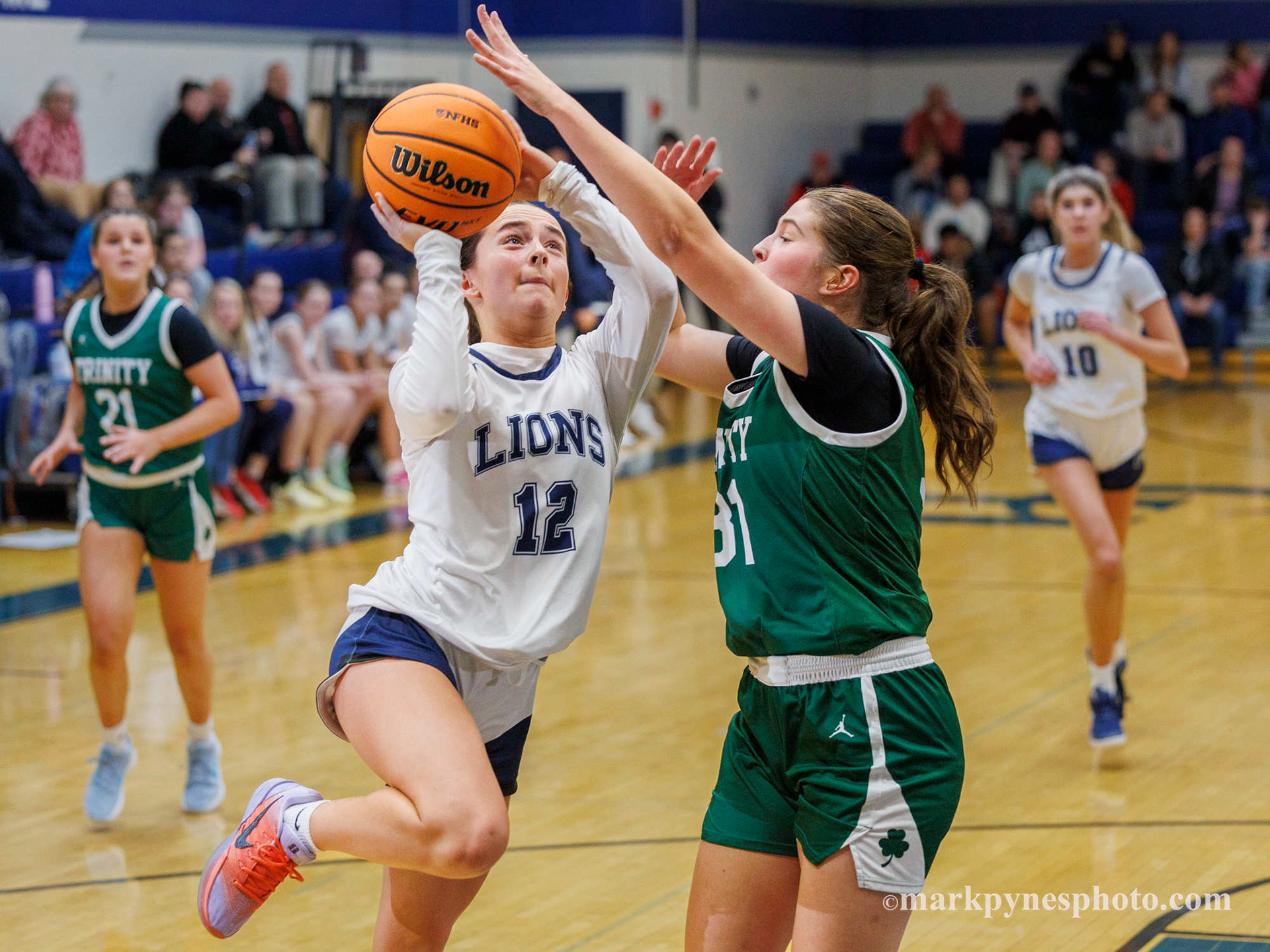 Cecilia Battisti shots a layup on Trinity defender Aryana McCleary but Trinity wins, 61-16.