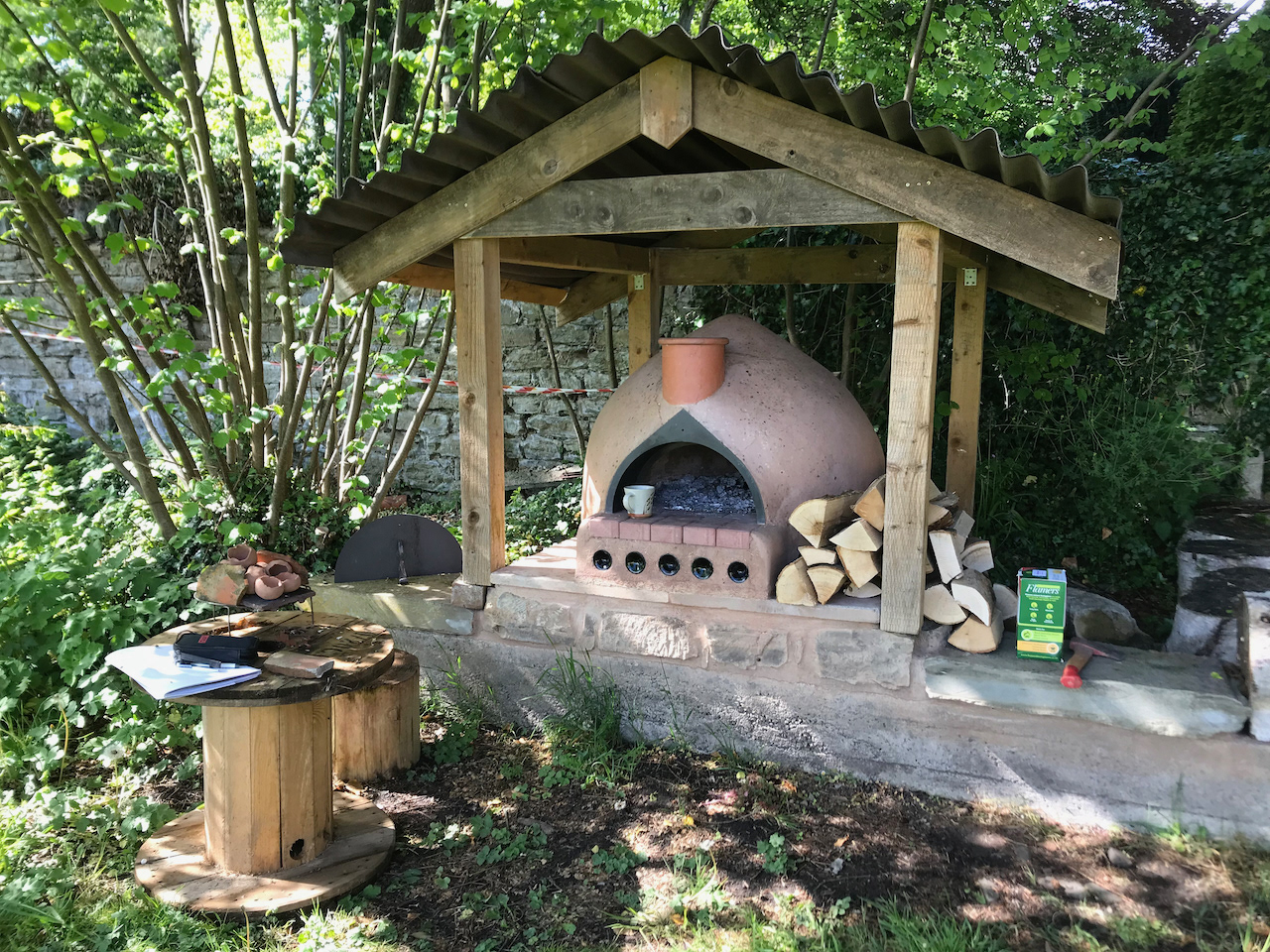 using a cob oven to fire the pots