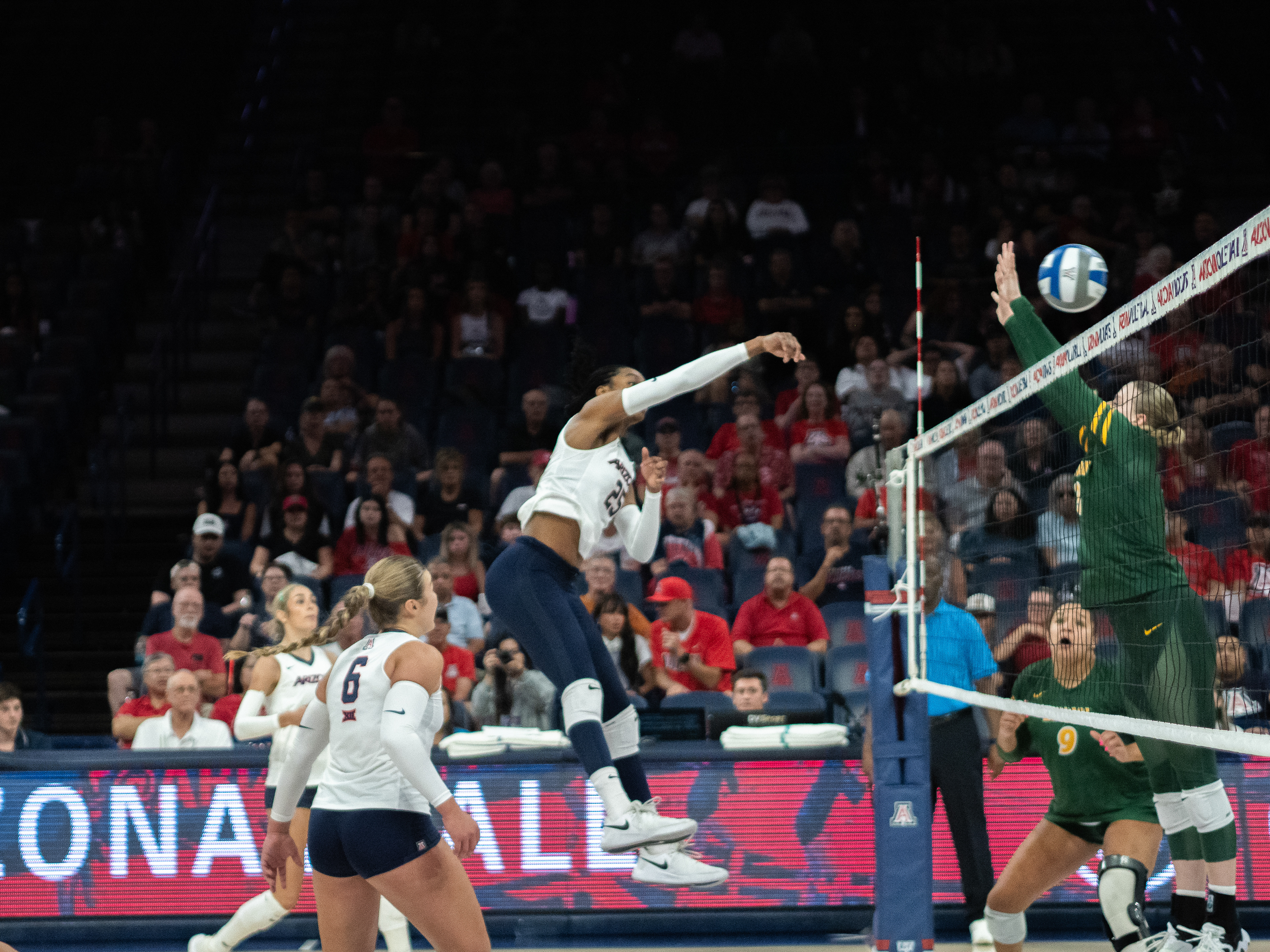Kiari Robey, number 25 on the University of Arizona Women’s Volleyball Team hits the ball past the defenses of the North Dakota team at the McKale Center on September 19, 2024. The University of Arizona Volleyball team won the game.