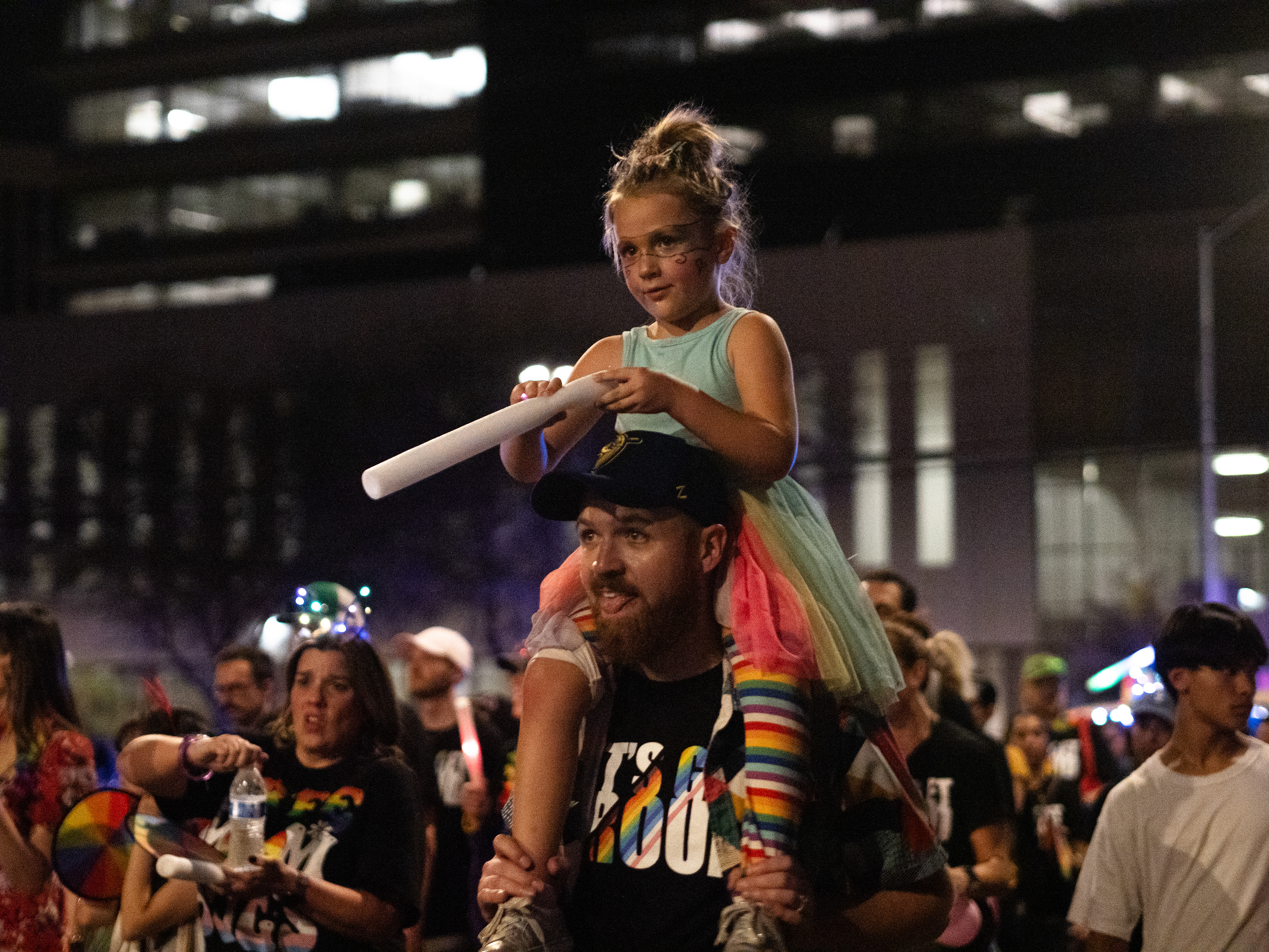 A child on the shoulder of an adult at the Tucson Pride Parade on Sept. 28, 2024, in Armory Park. There were many different types of parade floats in the pride parade.