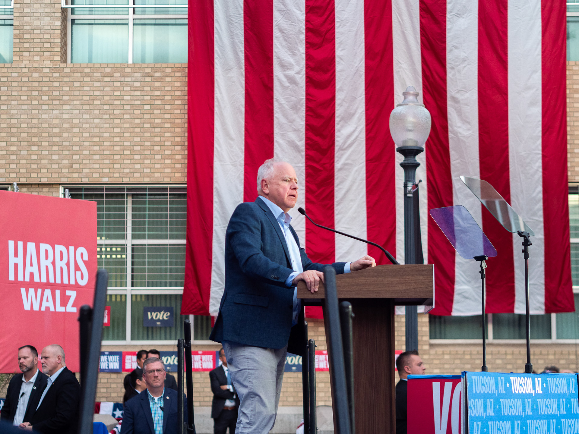 Tim Walz speaking in front of a flag at his rally at the Tucson Magnet High School on Nov. 2, 2024. The rally had several other speakers including Mark Kelly and Gabby Giffords.