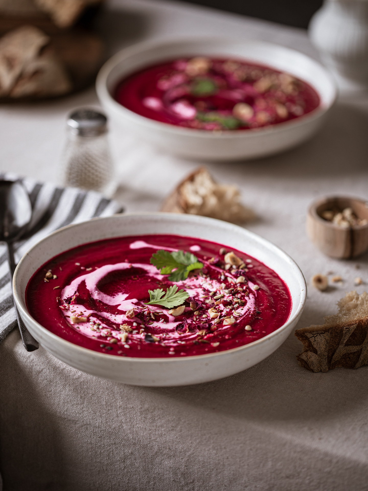 Food Styling Portfolio Image of a Beetroot Soup served on bowls as part of a table scene made by Ioana Ursu Food Photography