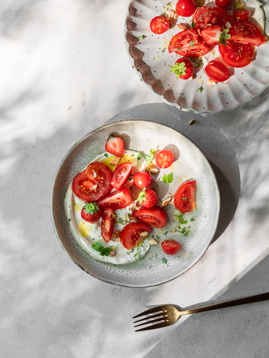 Tomato and strawberry salad recipe image served with hummus made by Ioana Ursu - recipe developer, photographer and stylist