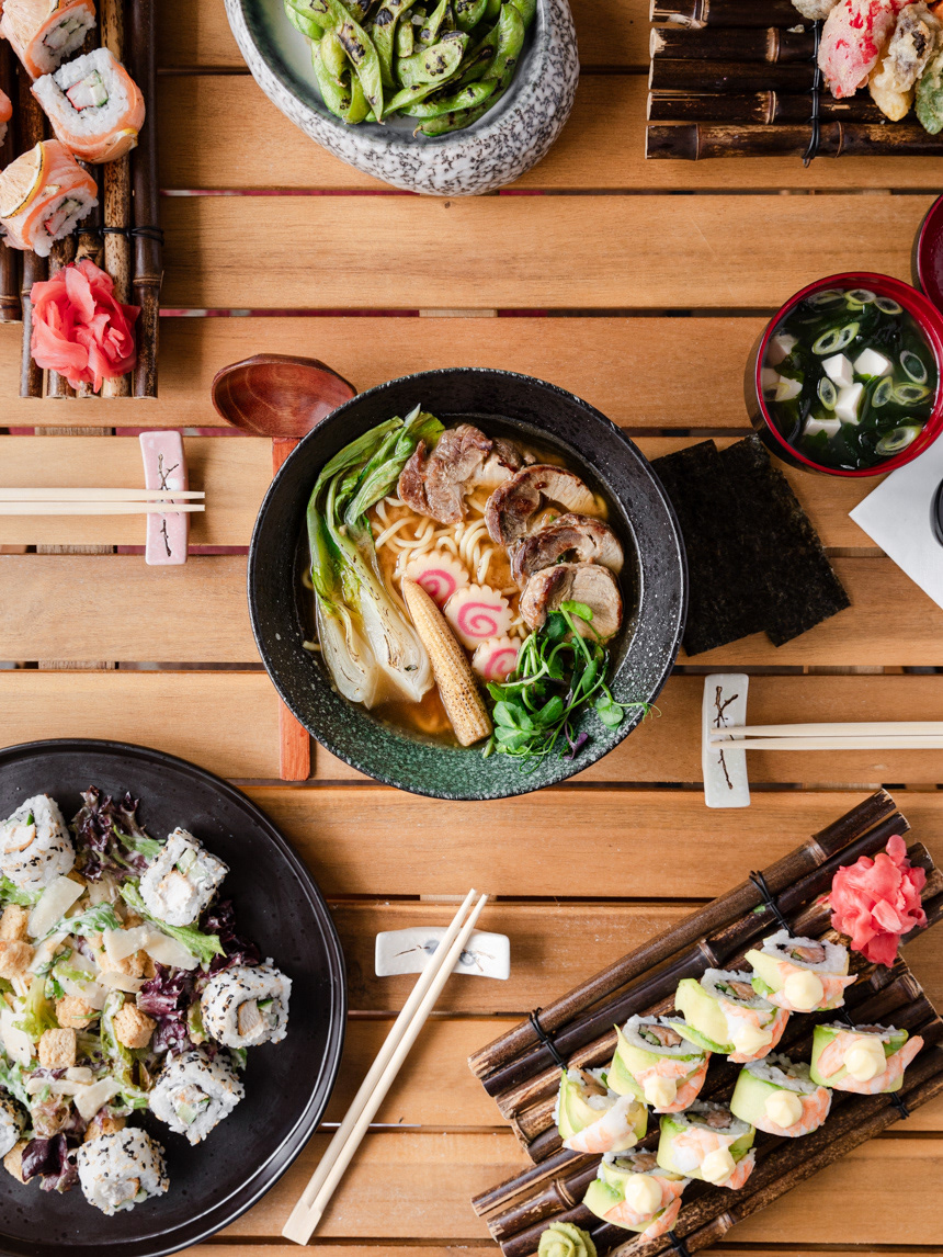 A restaurant photography image of various menu dishes such as ramen, flamed edamame, sushi, salad and miso soup photographed by Ioana Ursu food and restaurant photographer based in Warwickshire