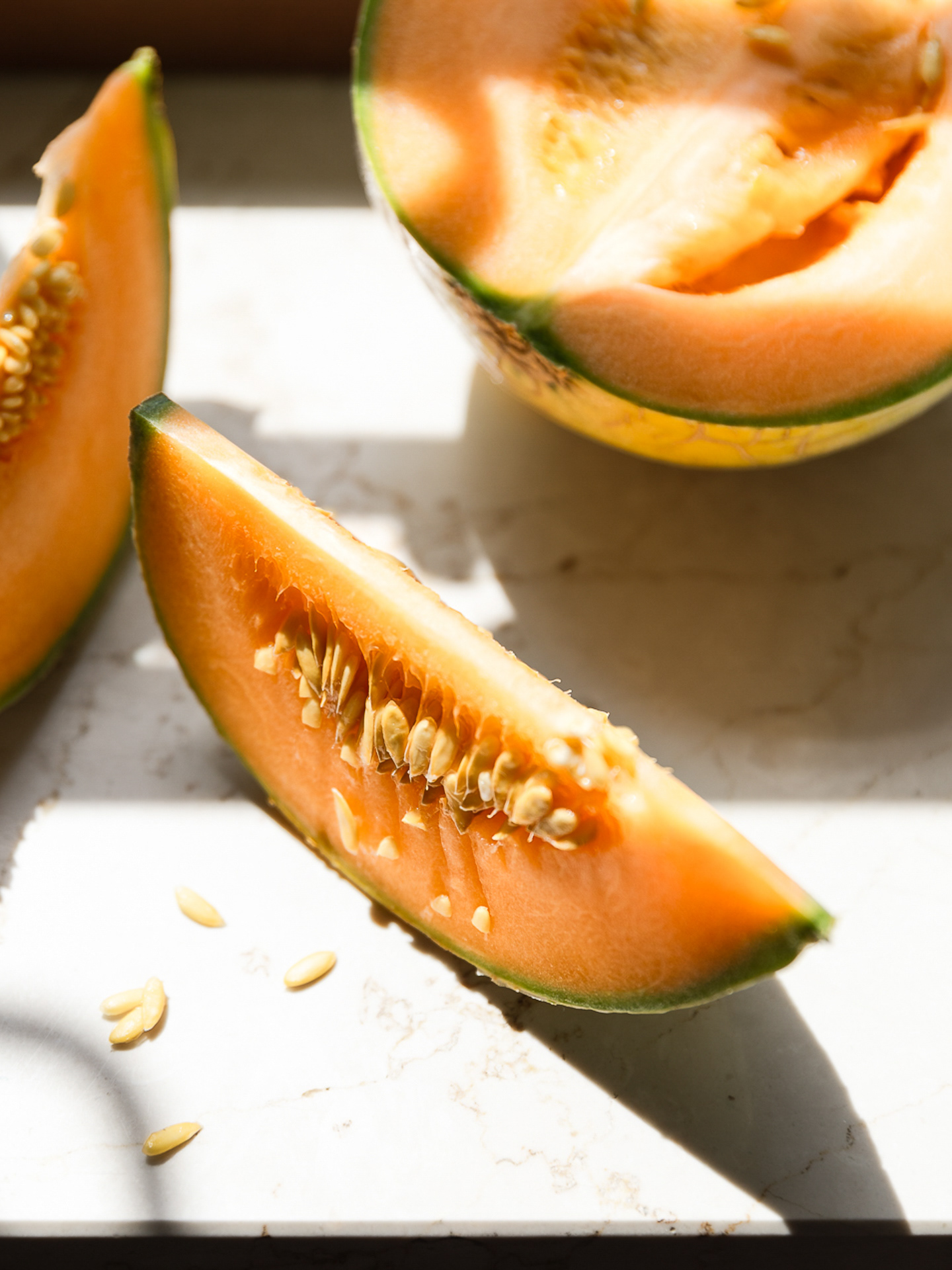 An image of a sliced melon captured in hard light by Ioana Ursu Food Photographer Birmingham