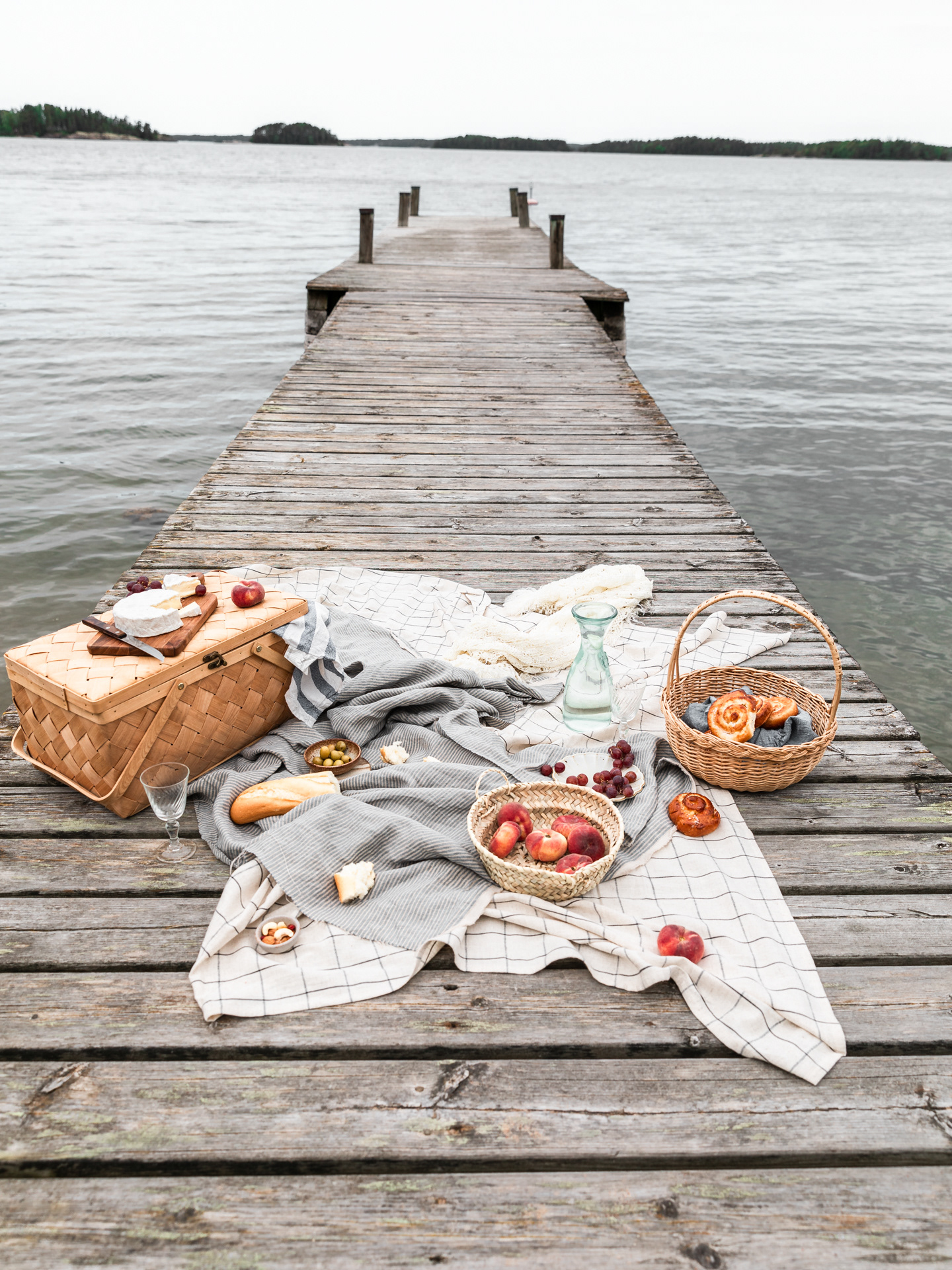 Lifestyle Portfolio Image of a picnic scene set up by the lake and captured by Ioana Ursu Lifestyle and Food Photographer based in Warwickshire UK