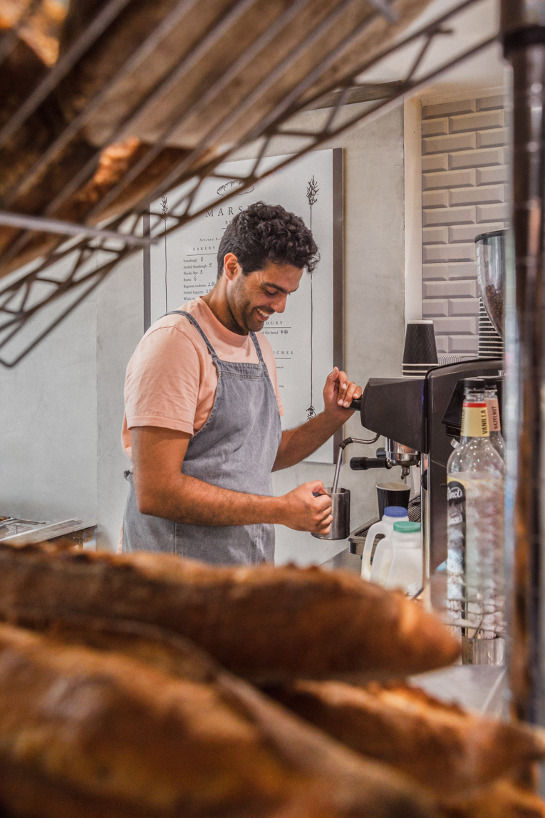 A cafe image of the barista making coffee in a bakery and cafe captured by Ioana Ursu restaurant and hospitality photographer based in Warwickshire
