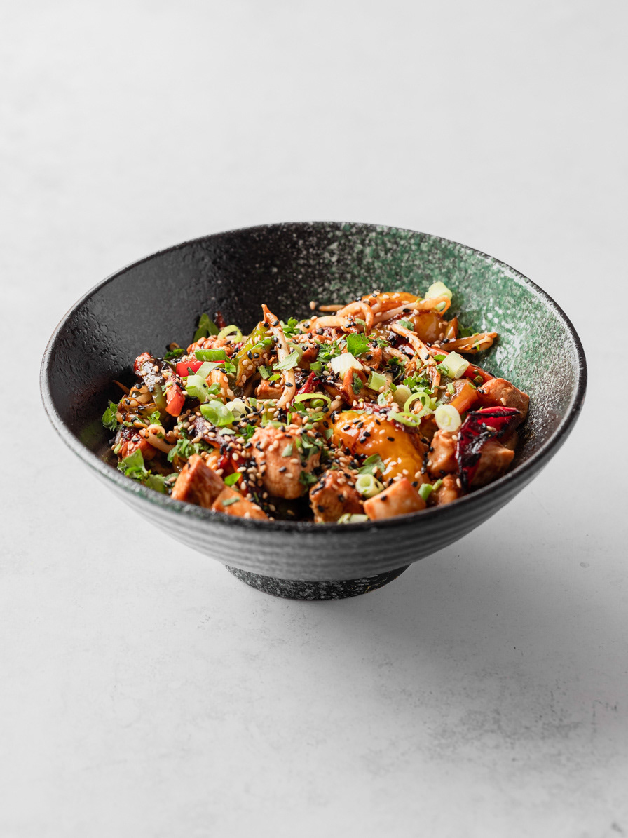 A restaurant photography image of noodles in a bowl, made with vegetables and prawns made by Ioana Ursu hospitality photographer based in Warwickshire, covering Birmingham, the Cotswolds and West Midlands area.