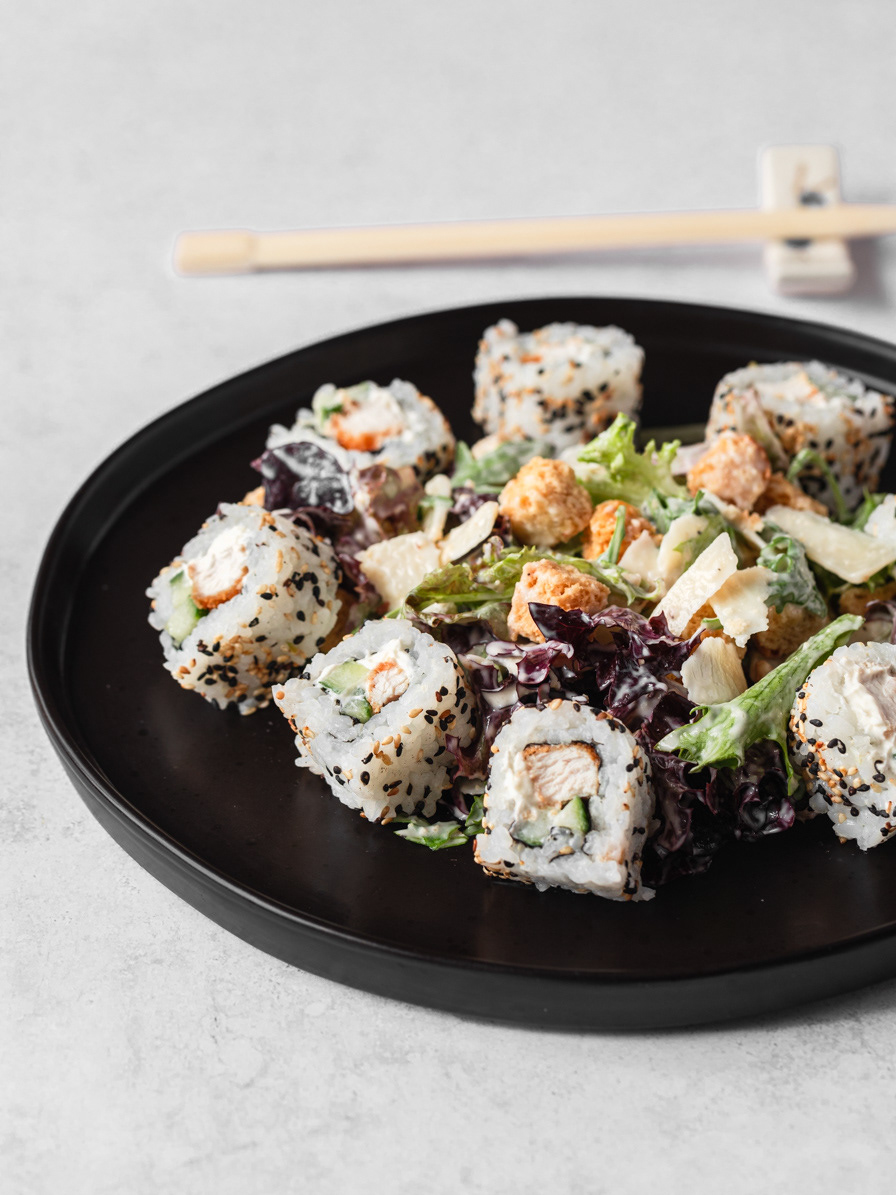 A restaurant photography image of a salad made with sushi, croutons, salad and shavings of parmesan, made by Ioana Ursu restaurant photographer based in Warwickshire