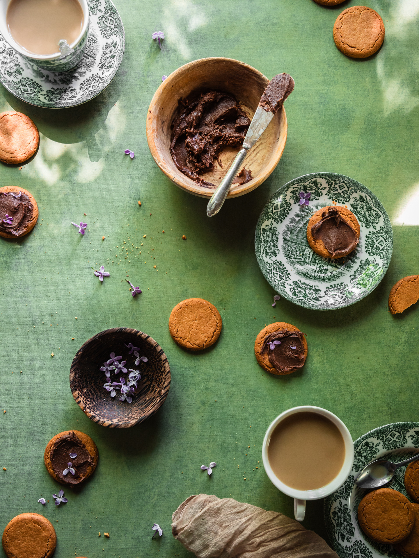 An image of a tea and biscuits scene and chocolate to spread on top styled and photographed by Ioana Ursu