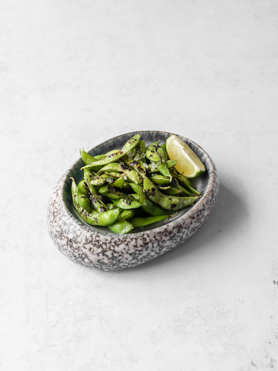 A restaurant photography image of flamed edamame with butter, sea salt and lime made by Ioana Ursu food and drink photographer based in Warwickshire