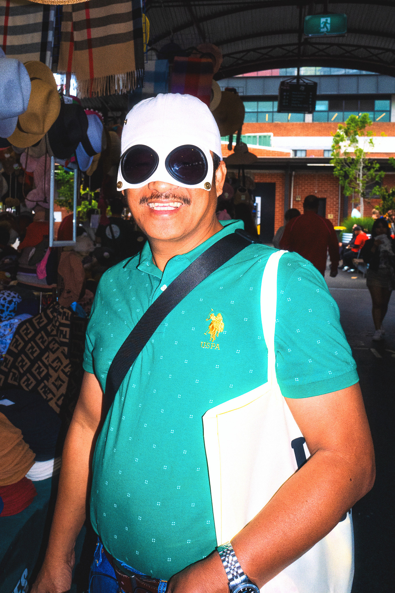 Tourist trying on sunglasses as Queen Vic Market in Melbourne