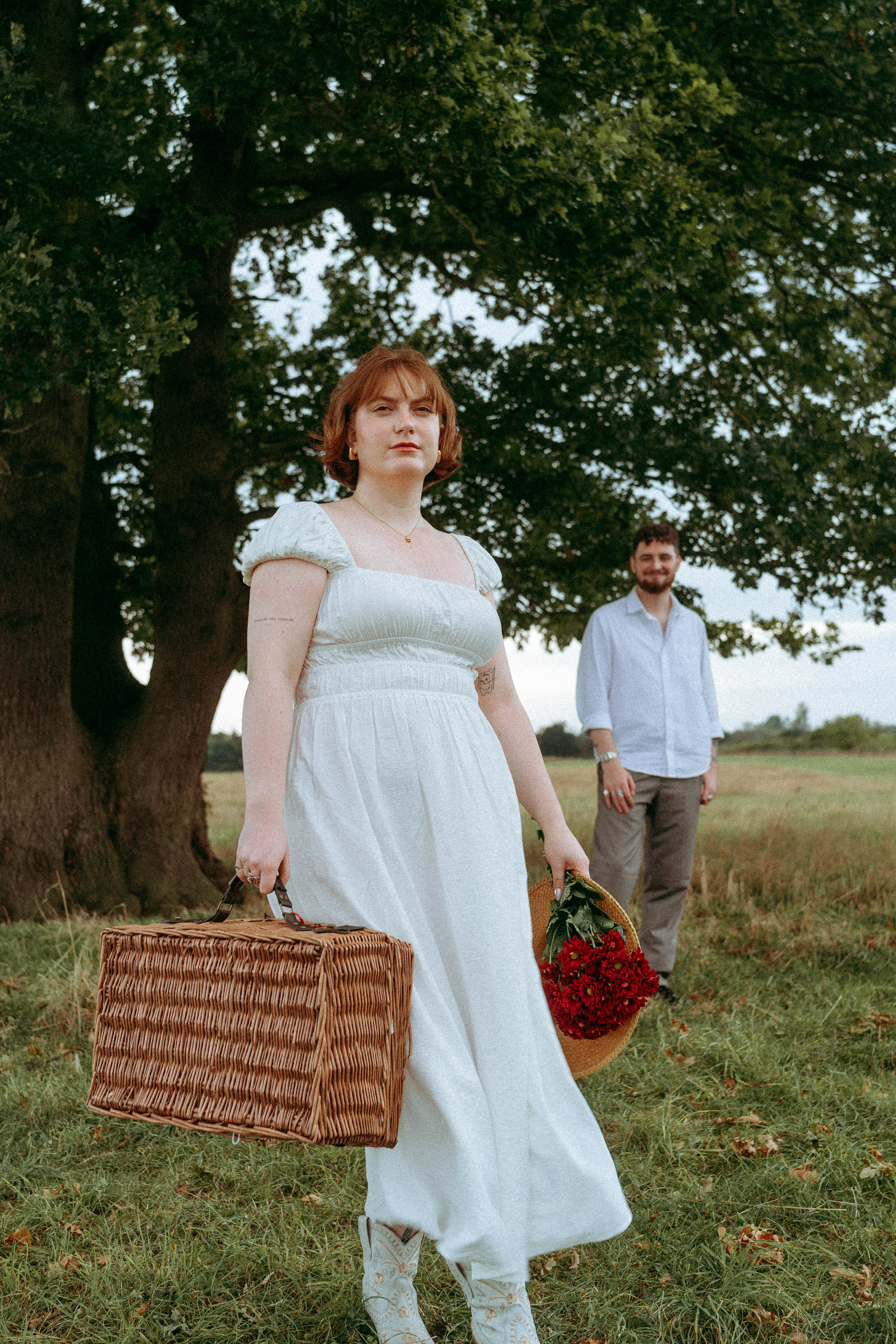 An intimate and playful engagement story set against a grand oak tree. A blend of romantic lifestyle photography and high-end editorial portraits, featuring a curated picnic setting in the Essex countryside.