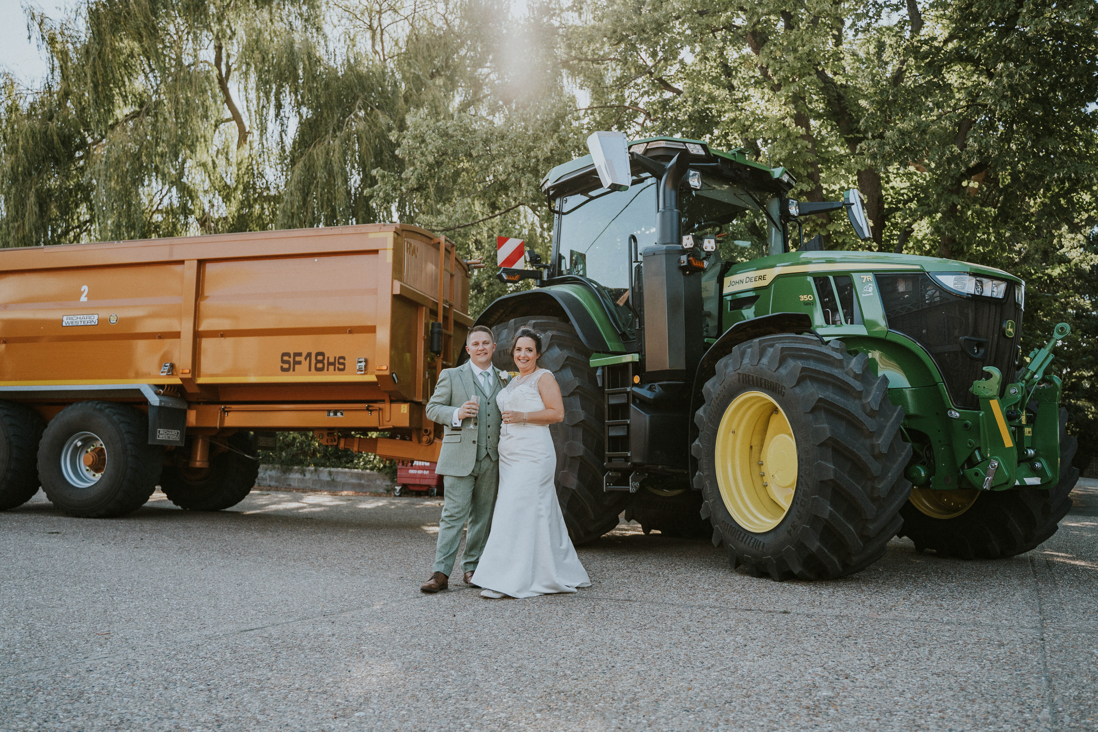Rustic and industrial wedding storytelling at Red Brick Barn, Sutton Hall in Essex. Featuring vintage tractors and authentic moments.