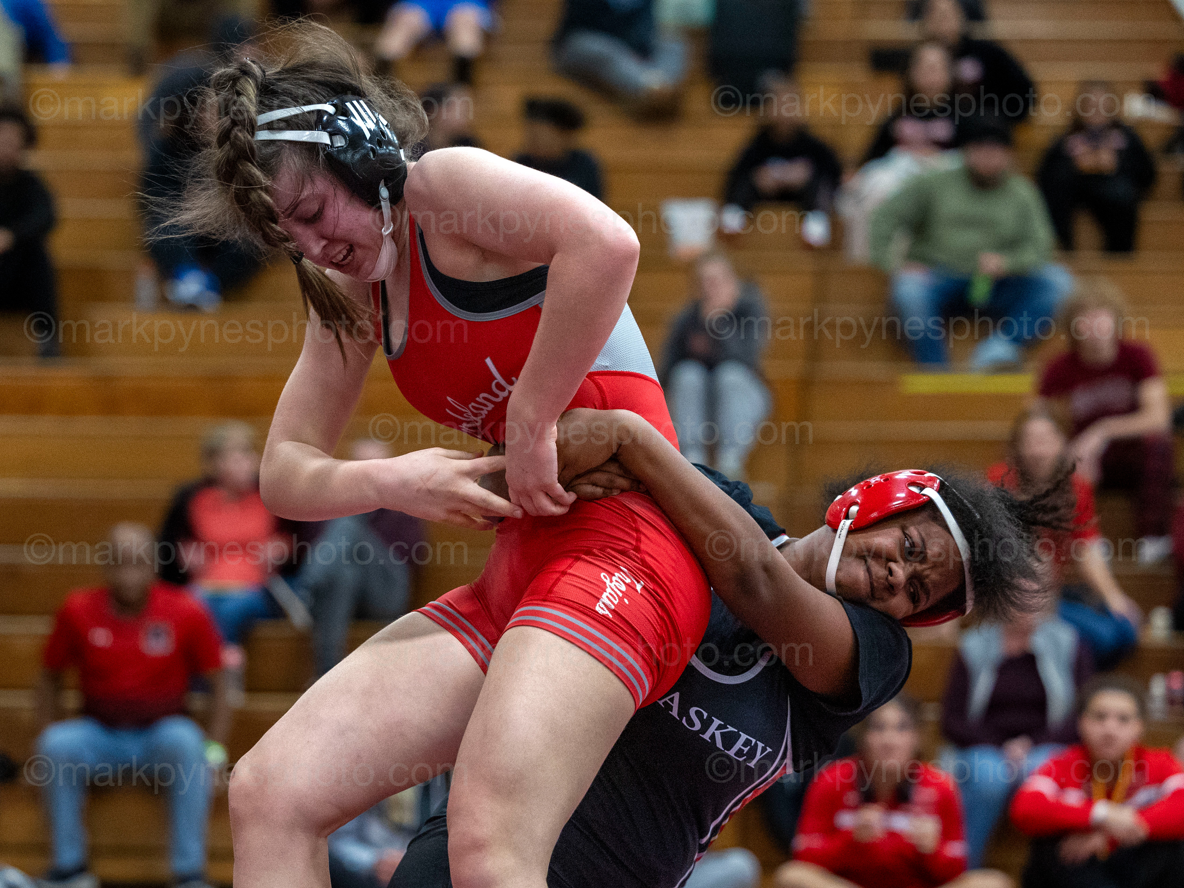 Natalie Deutsch, Parkland, tries to break the grip of J.P. McCaskey’s Kashmere Aguilera in the 155-pound final.