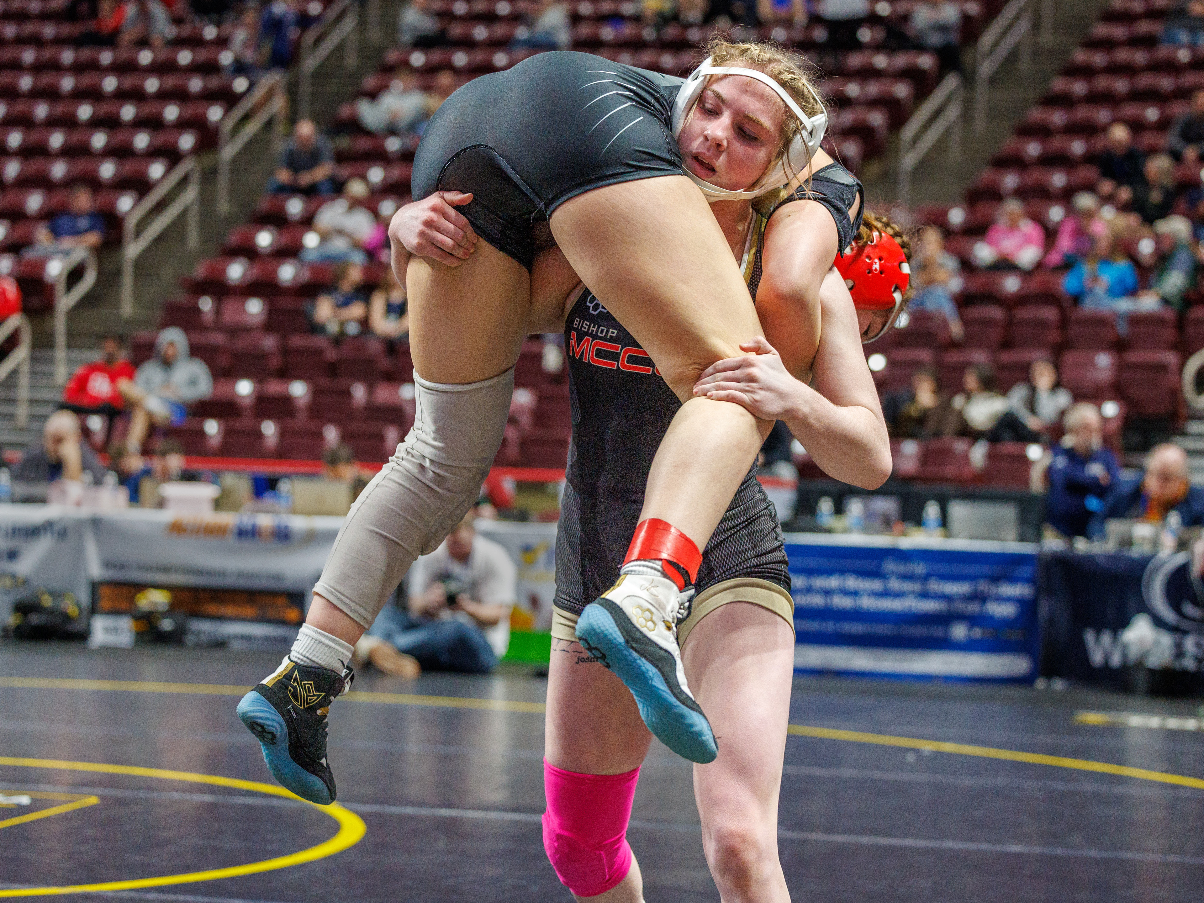 Jordyn Fouse (Bishop McCort) lifts Mariana Bruscino (Cumberland Valley), on the way to a 21-5, tech fall, in 1:32, in a 136-pound opening round match at the PIAA Girls Wrestling State Championships at the Giant Center in Hershey, Pa., Mar. 7, 2024.