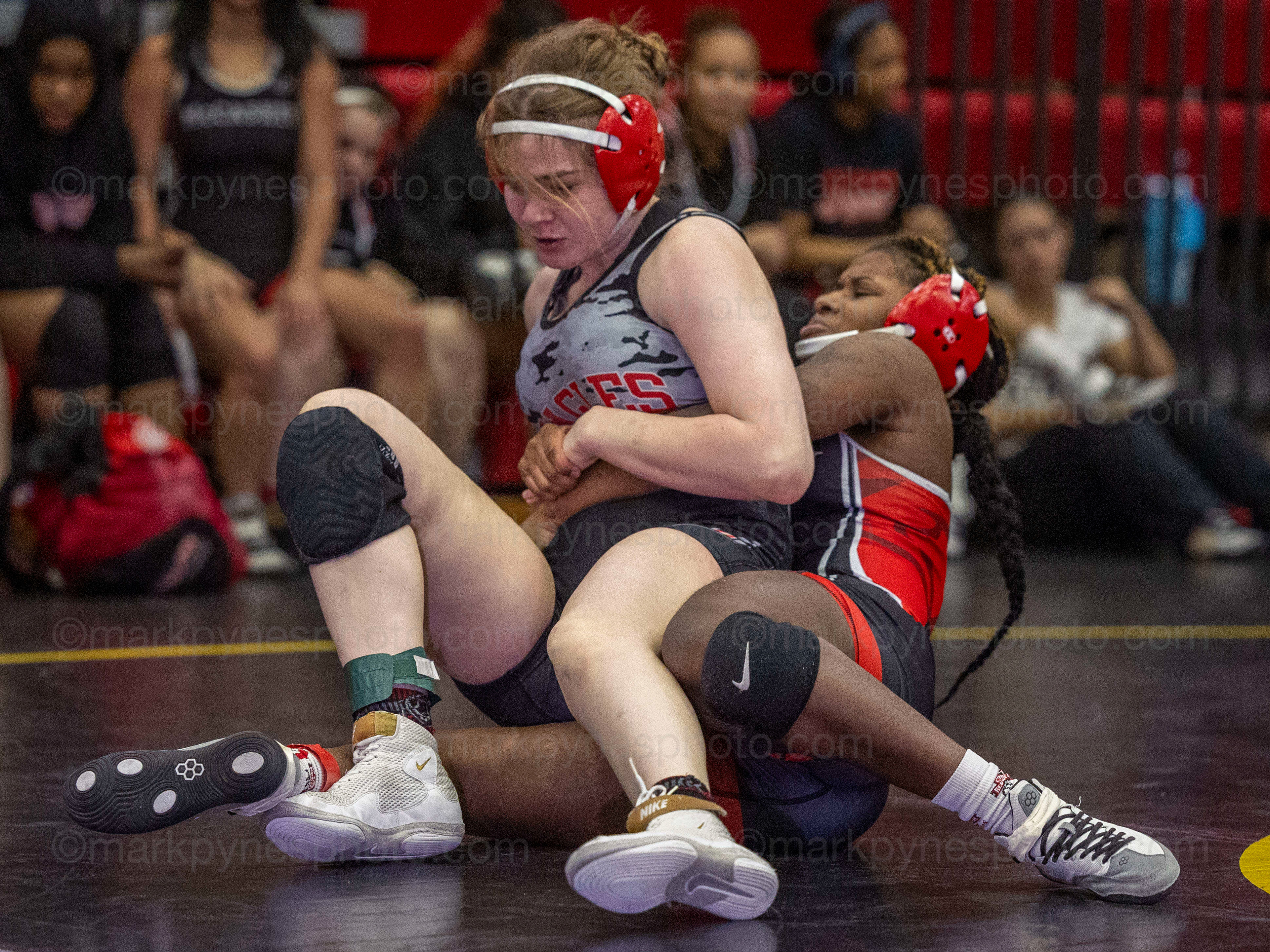 J.P. McCaskey’s Tyra Bookman throws Kendra O’Brien, Cumberland Valley, in the 148-pound match.
