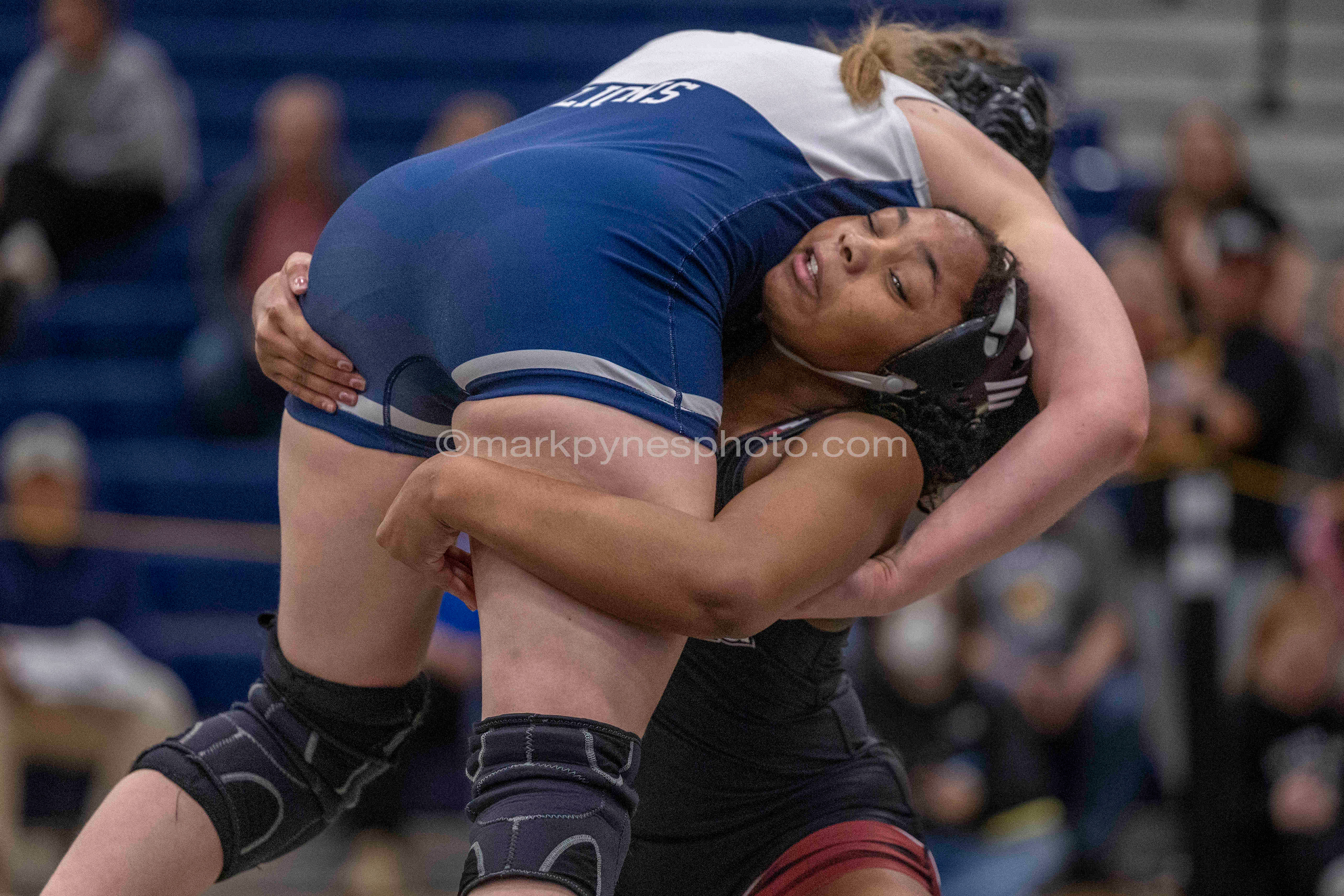 Adrianna Bowling, Gettysburg, lifts Keeley Nunn, Camp Hill, in the 155-pound final, on her way to a 12-11 decision.