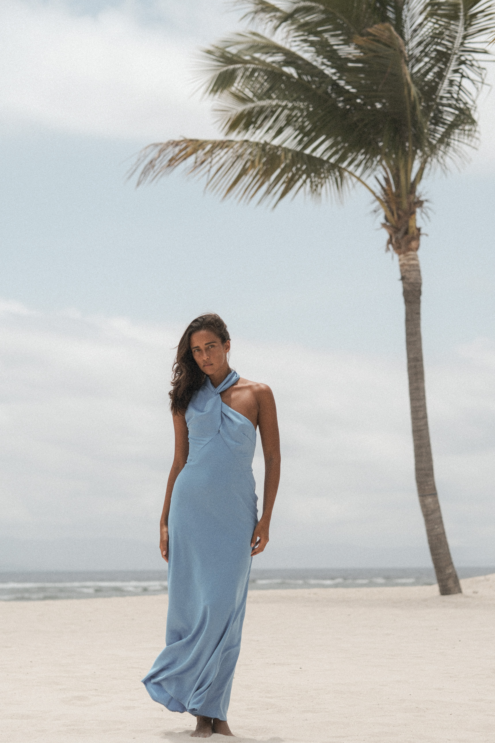 Full-length pale blue dress by the sea