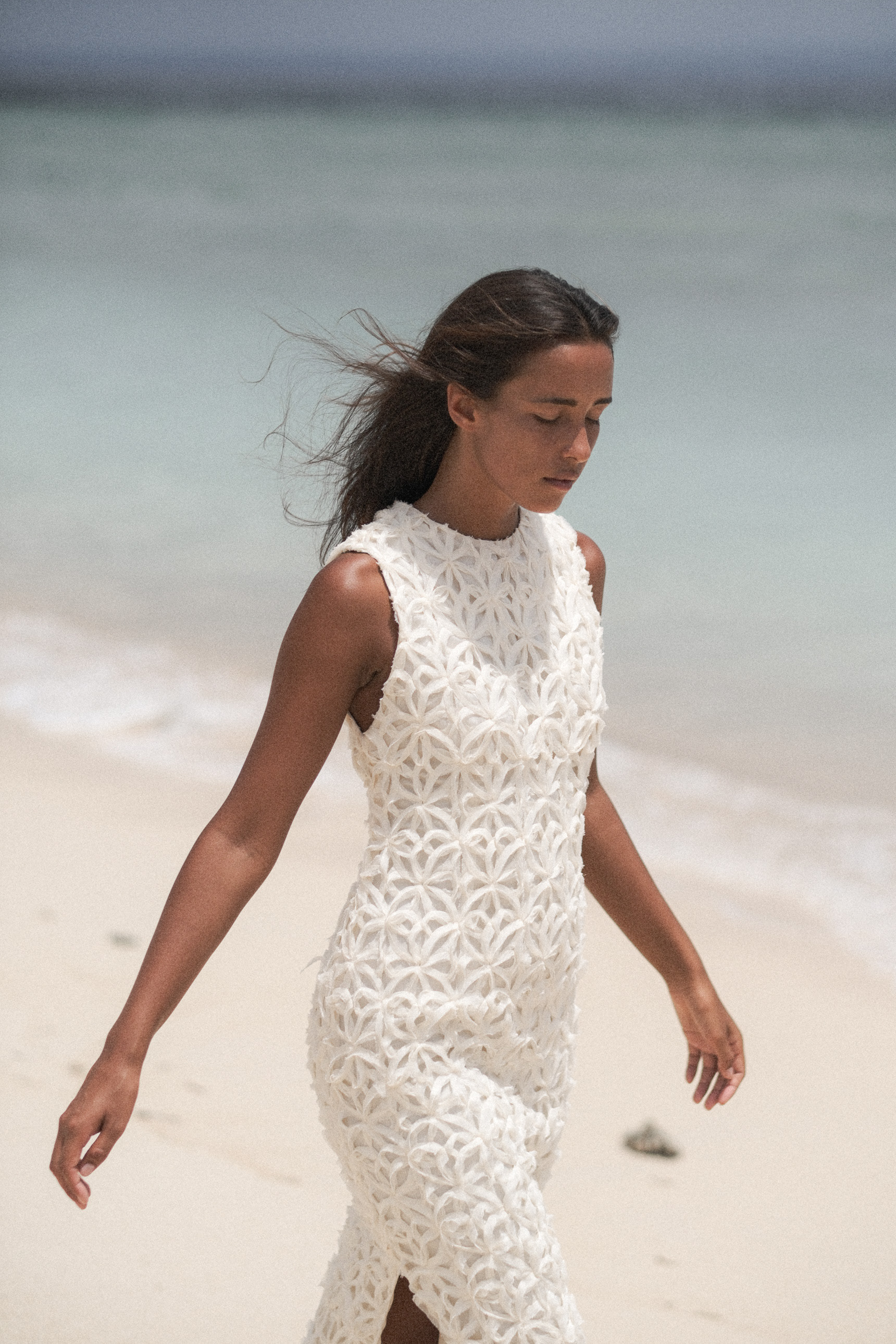 Model walking in a white textured dress