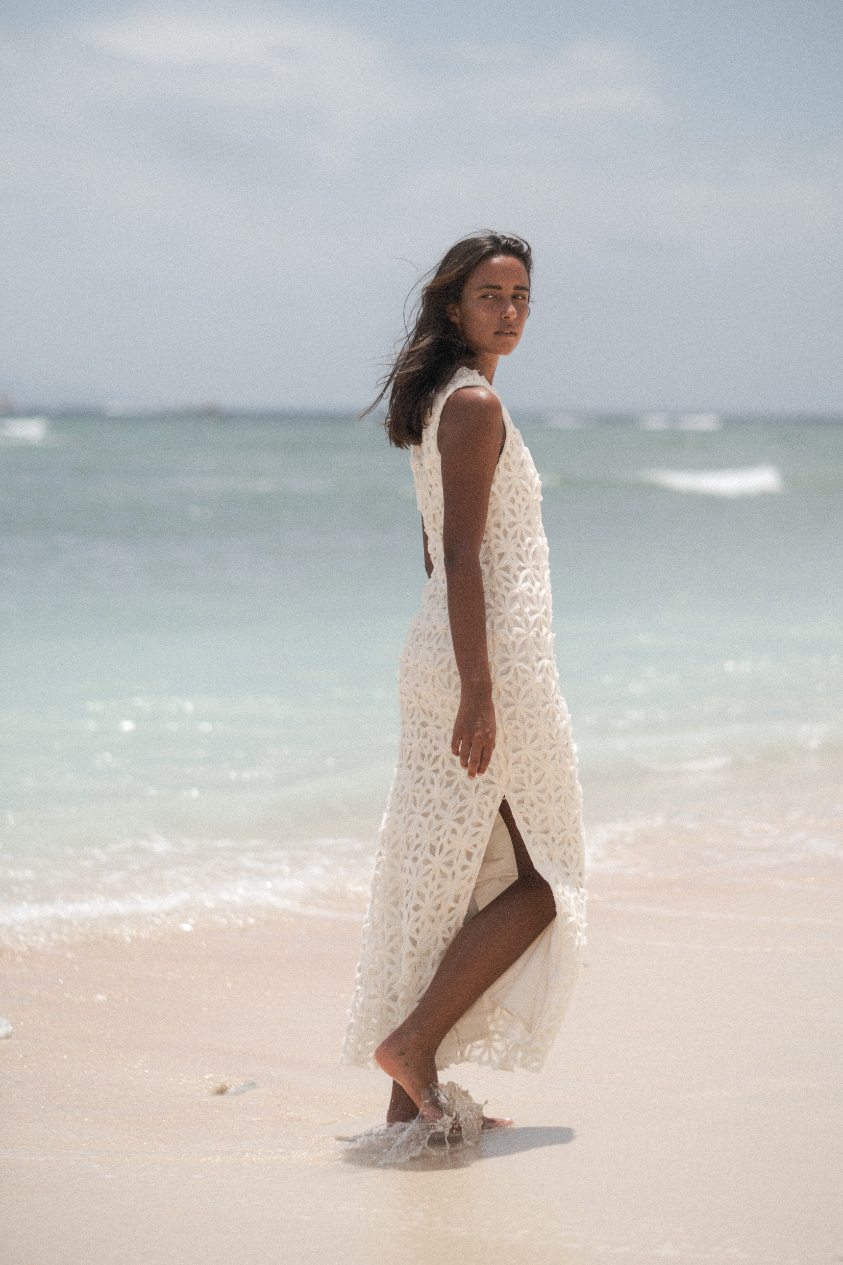 Back view of a white textured dress at the waterline
