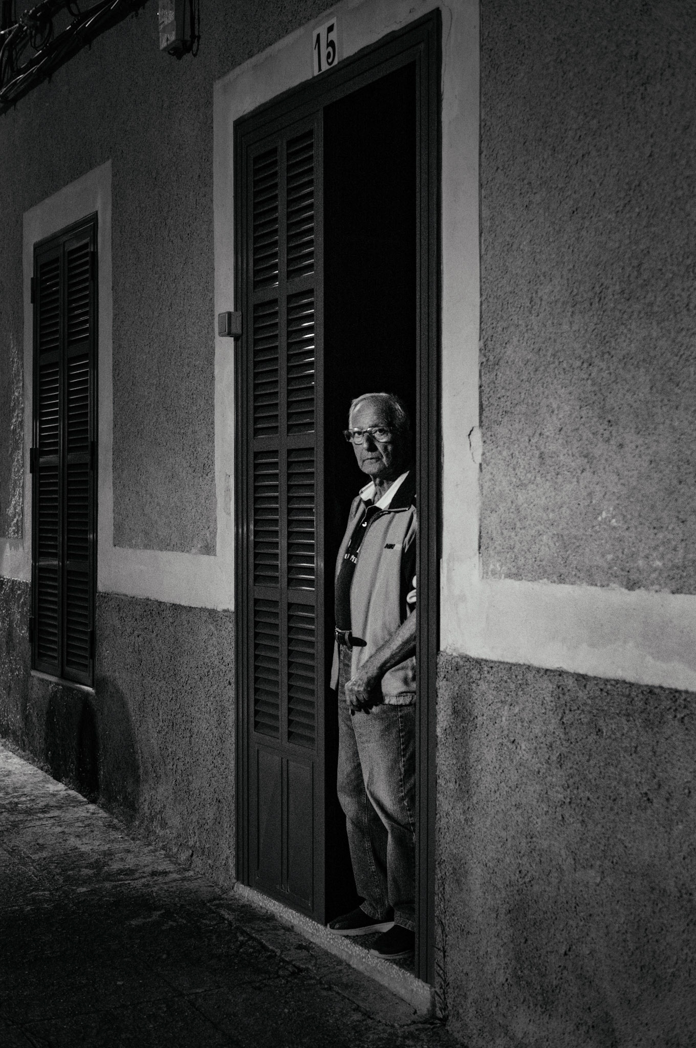 as I walked through the narrow streets of Felanitx, I saw him standing in the doorway, still and silent. I framed the shot, hoping he wouldn’t notice, but of course, he did. our eyes met, and I approached, telling him I had to take the photo. he looked at the picture, studying it carefully, then thanked me and wished me a good night. it was a quiet, almost intimate moment in the solitude of the evening.