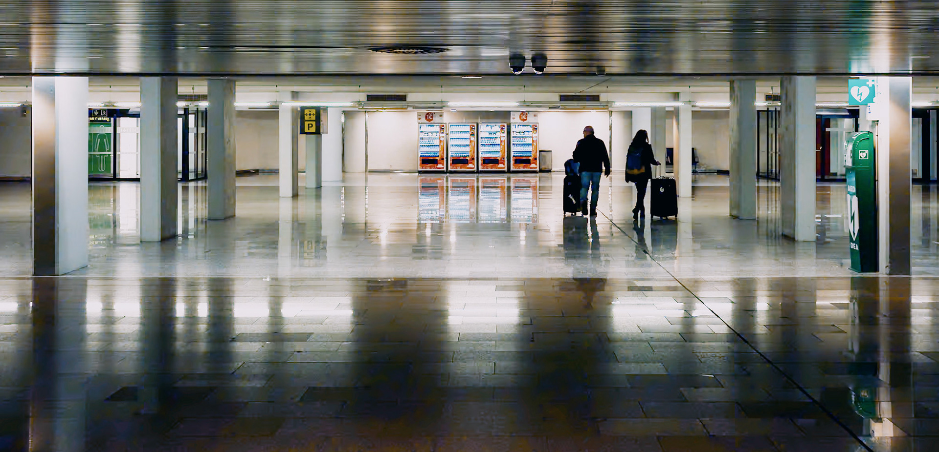 in the quiet corridors of palma de mallorca's airport, a couple pauses, uncertainty painted on their faces. they stand at the crossroads of bustling gates and silent halls, a private moment of hesitation in the public expanse. the polished floor reflects their silhouettes, doubling the intimacy of their indecision. this is a snapshot of travel's reality — not just the destinations, but the in-betweens, the moments of not knowing, the search for the right path.