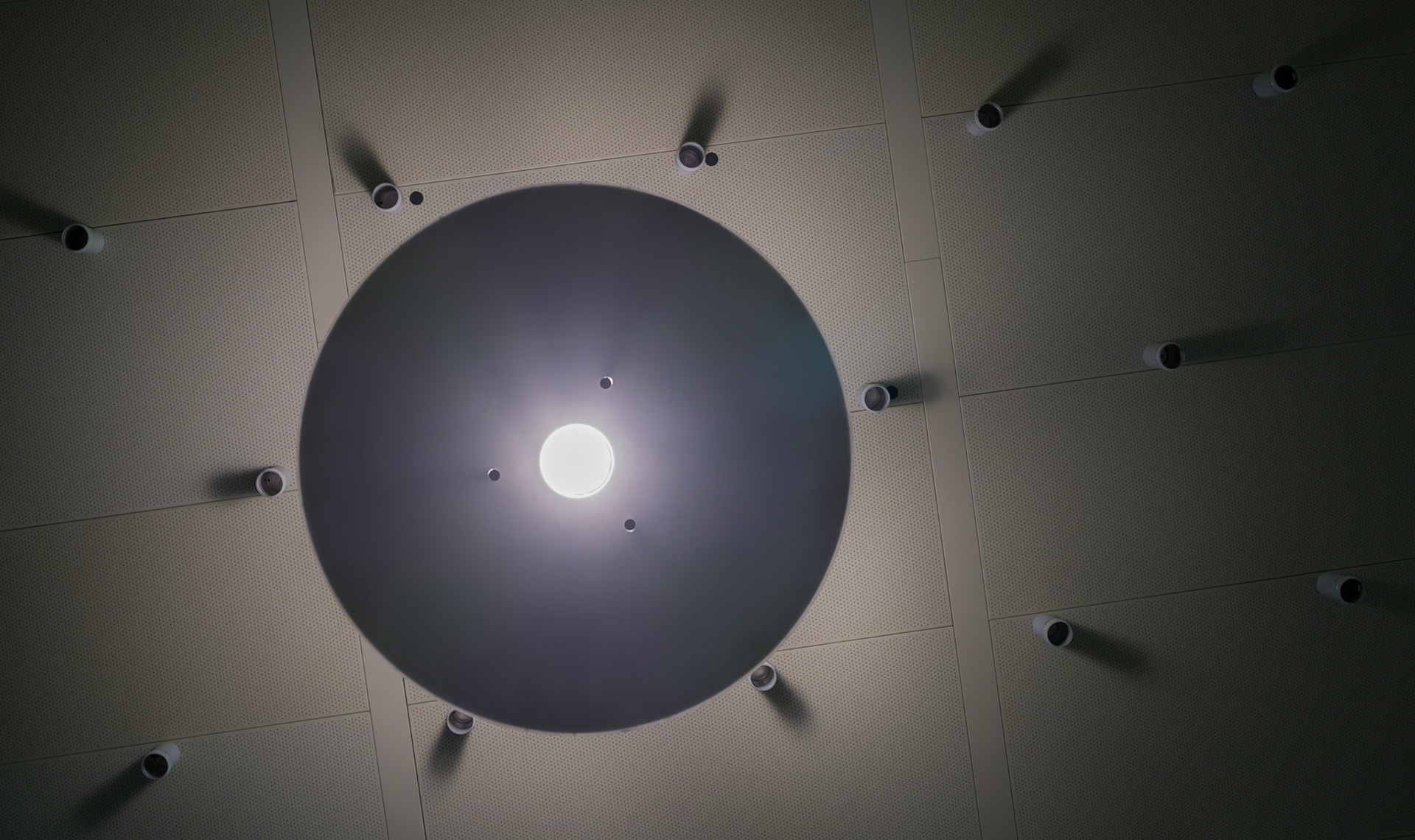 beneath the architectural ballet of hangover's airport, a constellation of ceiling lights casts a geometric dance of shadows and illumination. here, the interplay of light and dark sketches a silent symphony upon the surface, each bulb a soloist in an orchestrated performance of brilliance and contrast. the design, both purposeful and aesthetic, captures the eye, inviting travelers to pause and look upward, to find artistry in the mundane, a moment of beauty amidst the bustle of transit.