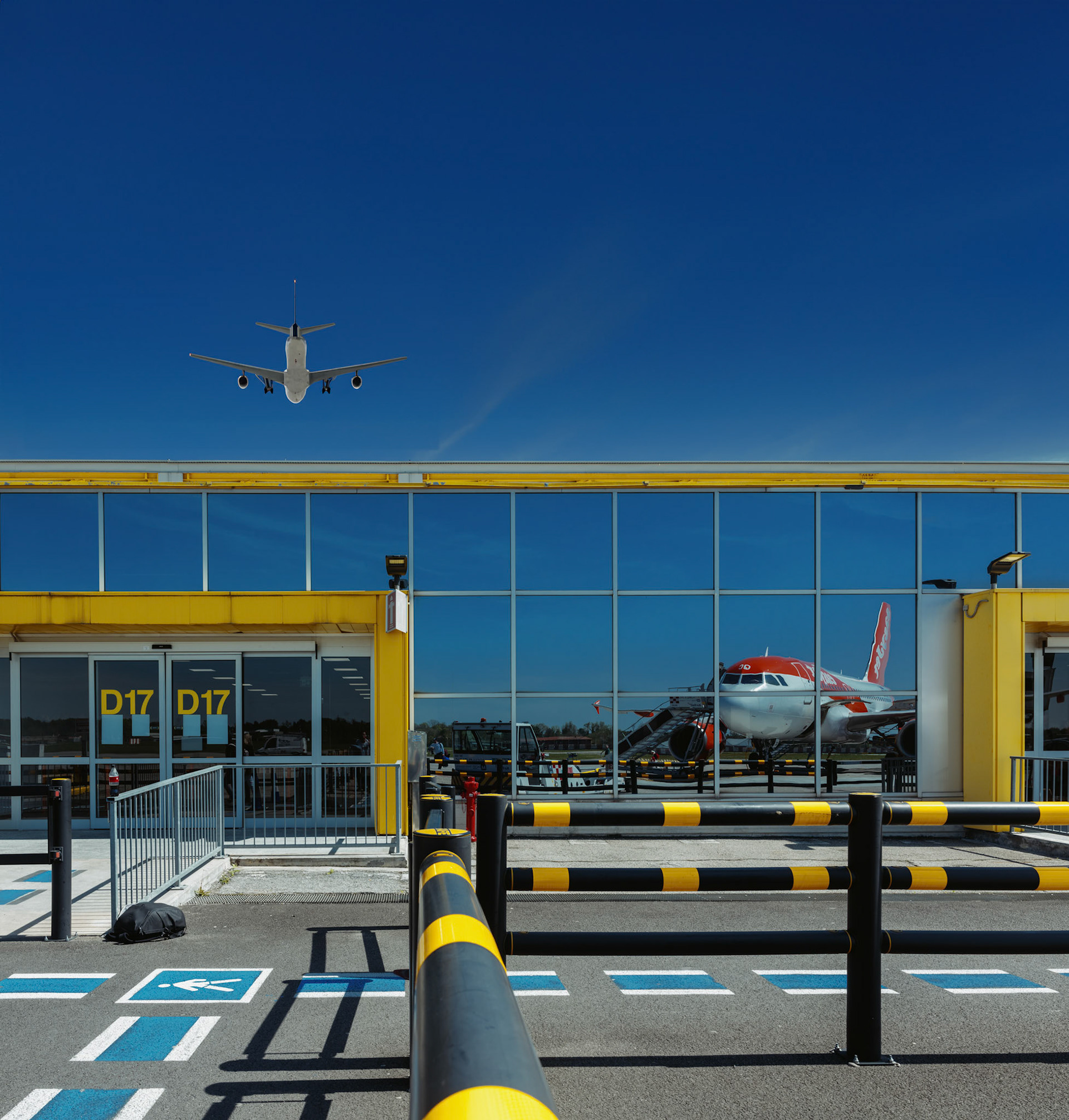 on the tarmac, reality and reflection converge in a dance of motion and stillness. a plane, cradled in the golden arms of the terminal’s embrace, becomes an echo on the sunlit glass—a doppelgänger caught between takeoff and touchdown. hues of industry and azure blend above, where another craft, borne from the realms of digital alchemy, floats in the boundless canvas of the sky. here, in malpensa's gateway, stories unfold in whispers of winged chariots, ferrying dreams across the globe.