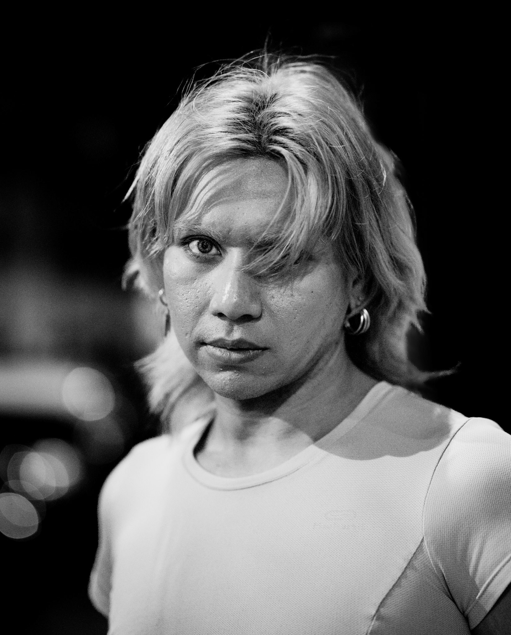 amid the rainy streets of montmartre, i crossed paths with this drag queen who moved with such grace and intensity through the night. despite being in a rush, she paused for a brief portrait, capturing a powerful gaze that speaks of resilience and elegance. the grain, moody light, and soft bokeh reflections mirror montmartre’s timeless charm, wrapping this moment in a film-like aura. it's an intimate slice of parisian night life, set against the rain-soaked glow of the city that never loses its allure.