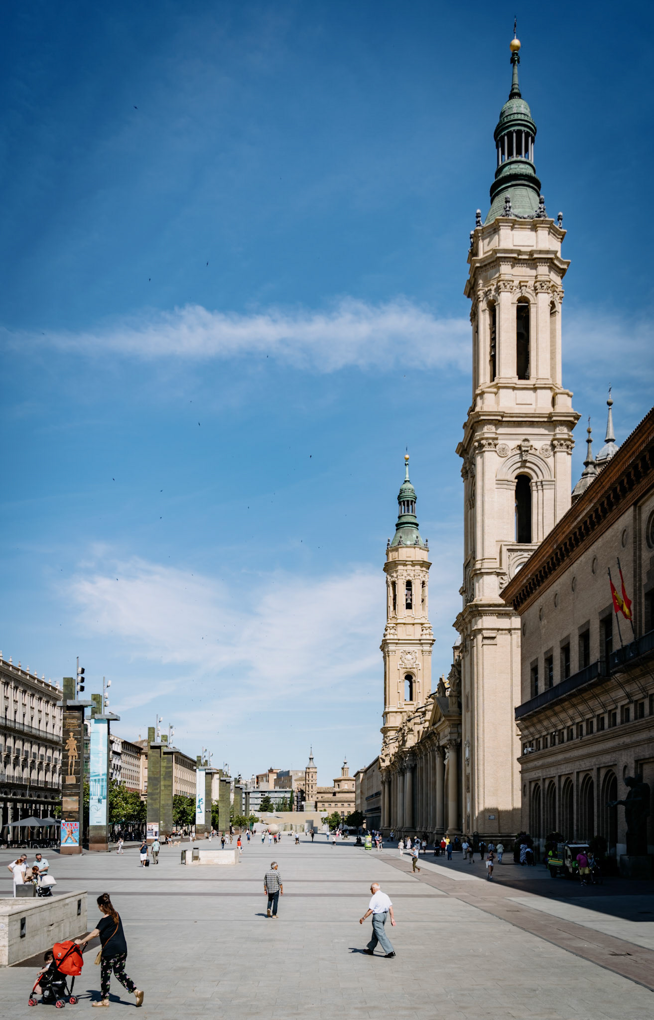 the basilica of our lady of the pillar in zaragoza is an iconic baroque church, a national monument of spain. it's renowned for its connection to the virgin mary and is a key spiritual site, much like santiago de compostela. the basilica features a blend of mudejar and baroque styles, marked by a distinctive array of domes and bell towers. its interior houses important art, including frescoes by goya, and the santa capilla with the revered statue of the virgen del pilar. the basilica stands as a testament to the religious and architectural heritage of spain.