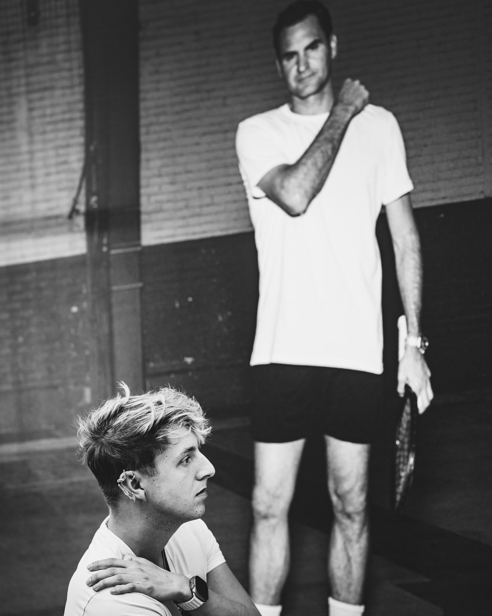 in the sleek, modern halls of the Uber Arena in Berlin, the camera captured an unexpected yet poignant moment. soeren, deep in thought, sits before the giant image of roger federer, whose legendary presence looms like a quiet mentor in the background. there’s an unspoken connection here — the dream of greatness and the reality of reflection. the juxtaposition between the two evokes a feeling of quiet admiration, where past achievements inspire present contemplation. this image speaks to anyone who's found themselves pondering their own path while looking up to a hero.