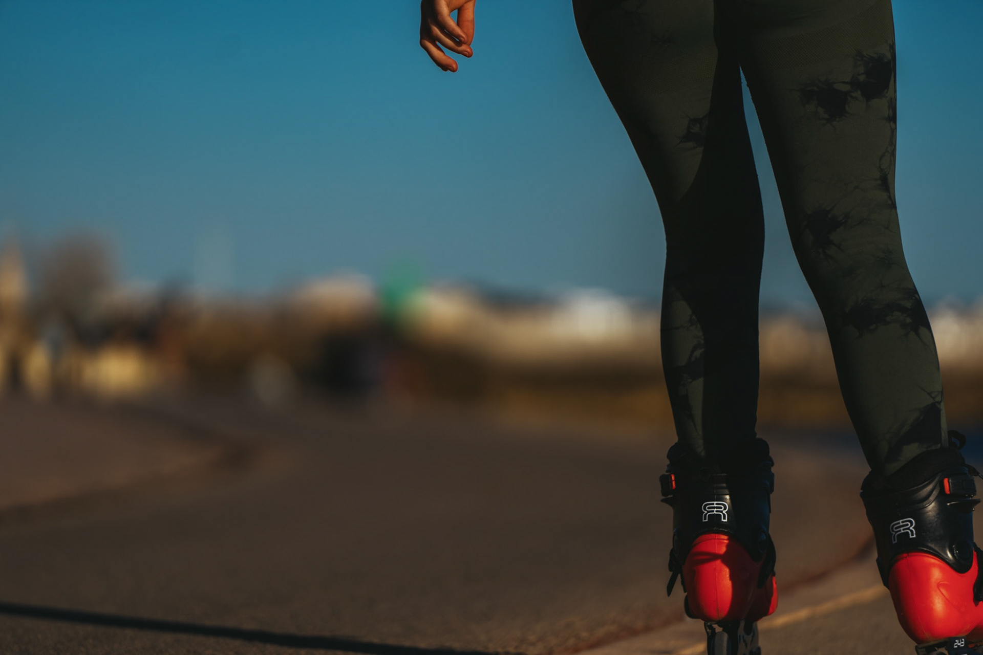 along the promenade of portixol, the click of wheels and the whisper of the sea merge. a close-up of legs mid-glide, adorned in olive patterned leggings and framed by the blur of the urban shoreline, tells a tale of balance and momentum. behind the bold red of the rollerblade brakes, there's an echo of freedom, a syncopated rhythm that beats to the pulse of palma de mallorca's maritime quarter. it's the essence of movement, captured against the laid-back tempo of a city that moves with the tides.