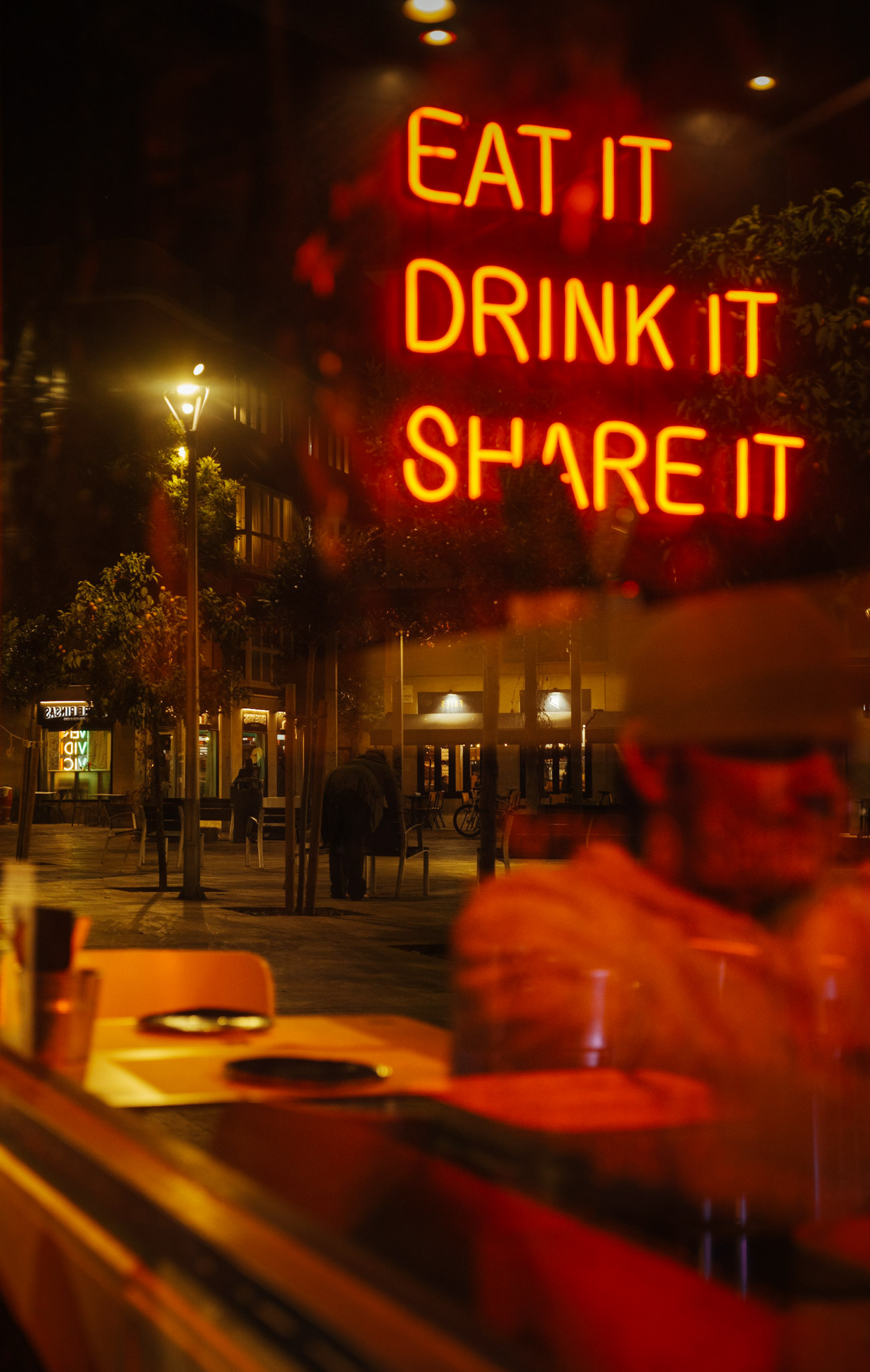 during our dinner at the kasui restaurant in palma de mallorca, I captured this image reflecting the scenery of plaça de raimundo clar through the restaurant's window.