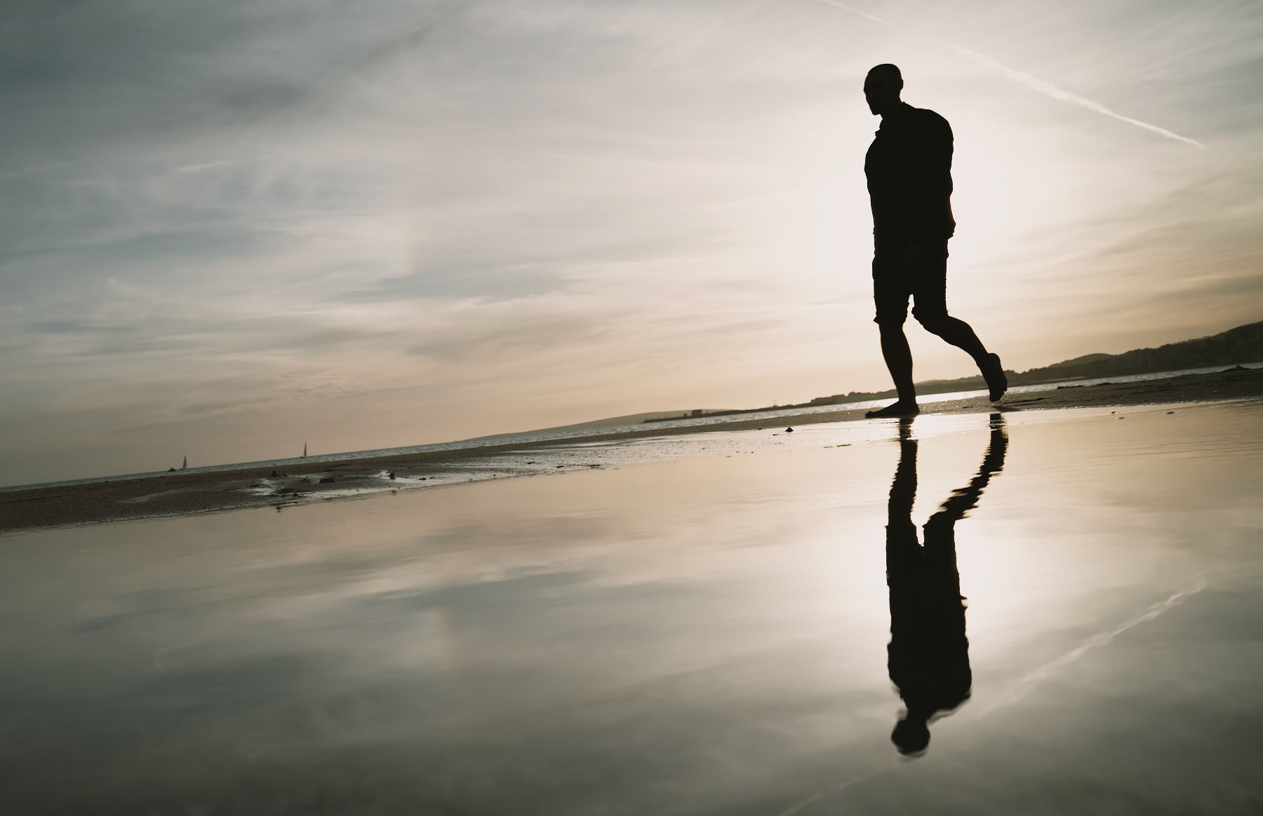 the tide whispers secrets as it recedes, leaving behind a mirror for the sky on the sands of palma. a lone wanderer, a silhouette against the canvas of twilight, is caught mid-stride, his reflection a perfect twin below. the horizon blurs the sea into the heavens, while the last rays of the sun play hide and seek with the clouds. it's a moment suspended, a dance between light and shadow, where time seems to pause for a breath, and the world is reflected in a single, thoughtful step.