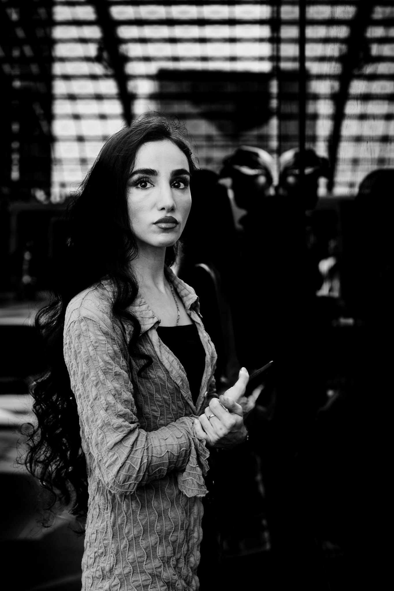 a fleeting moment amid the chaos of berlin’s main train station – an intense glance that, for just a second, seems to pause the city's hustle. framed by the reflective glass architecture and the blur of passing commuters, this is a moment of quiet amidst the rush. every detail, from the flowing hair to the piercing gaze, captures the subtle beauty of everyday life.
