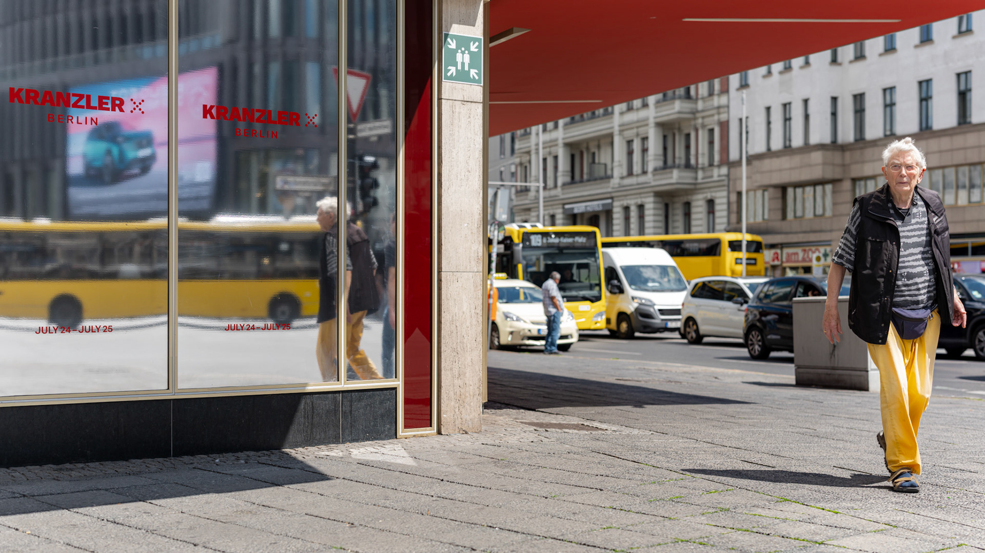 beneath the vibrant red awning of the legendary café kranzler on berlin’s kurfürstendamm, a scene of urban poetry unfolds. the elderly man, clad in striking yellow pants, strides with quiet confidence, embodying the pulse of the city. the iconic yellow berlin buses, including a double-decker in the background, weave harmoniously with his reflected image in the café's glass, creating a visually cohesive scene. this image captures the essence of berlin’s dynamic streets, where bold colors and fleeting moments of everyday life come together in a vivid dance of color and motion.