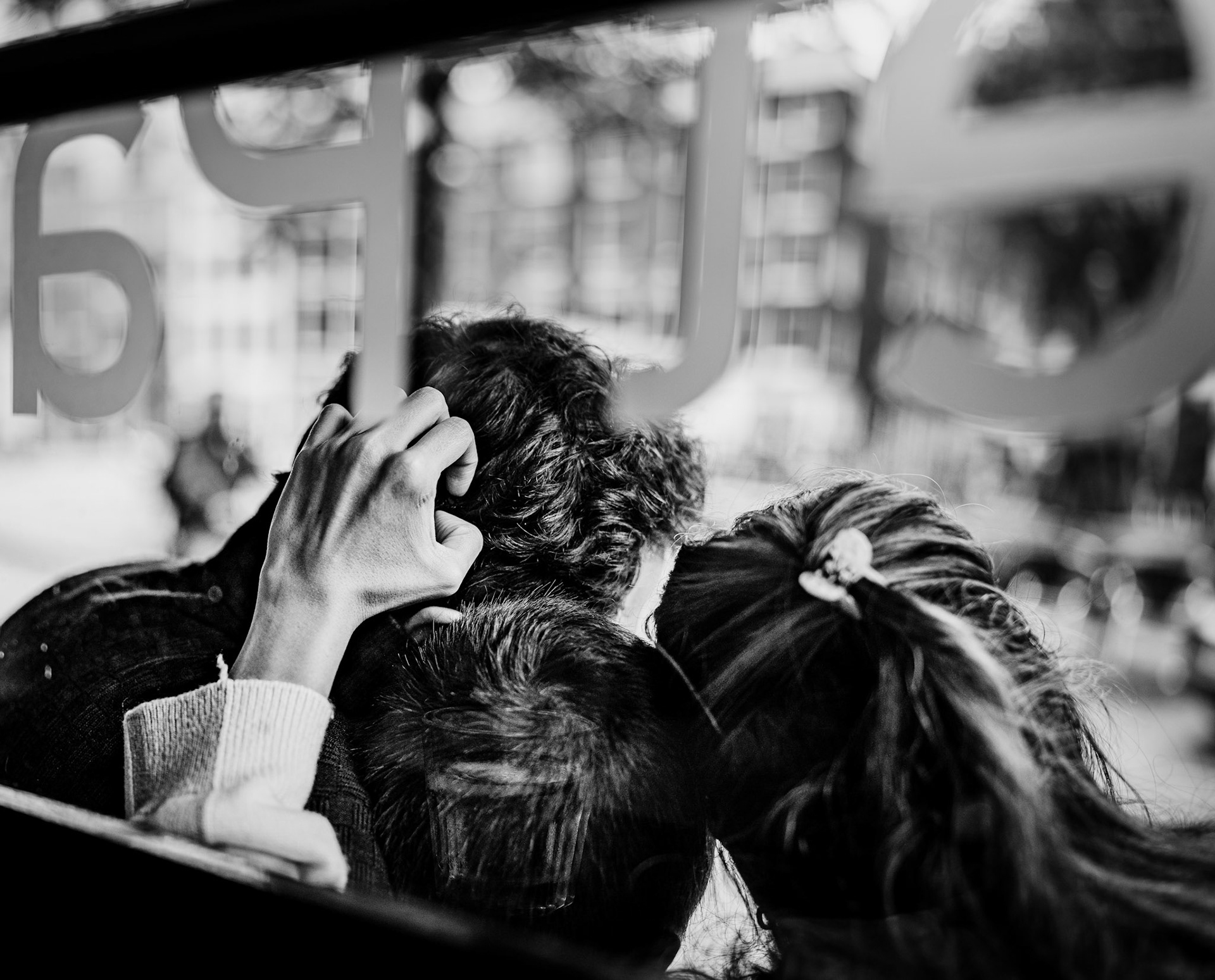 in the café het palais, amidst the hum of amsterdam's life, this quiet moment of intimacy unfolds. the gentle touch of hands, the soft embrace, and the blurred city beyond the window create a scene of pure, unspoken connection. it's a snapshot of love woven tightly together, a fleeting yet eternal moment where the world outside fades into insignificance, leaving only the warmth of togetherness.