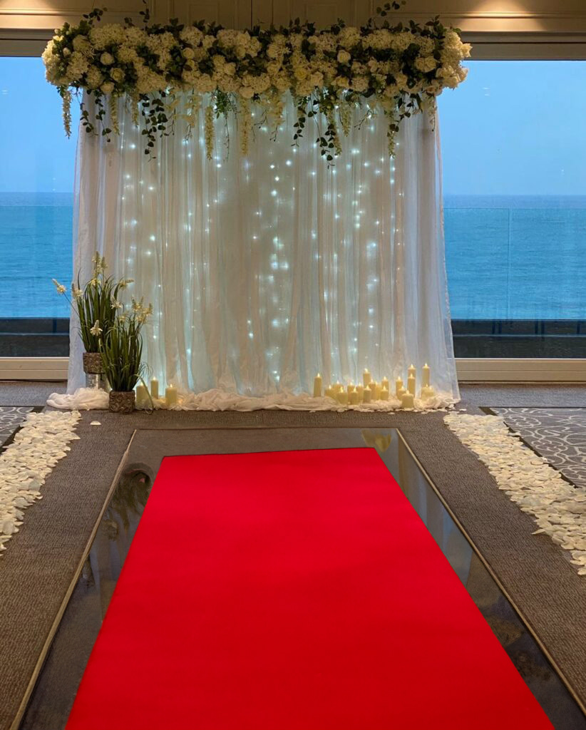 Ceremony White Greenery Backdrop with Red Carpet