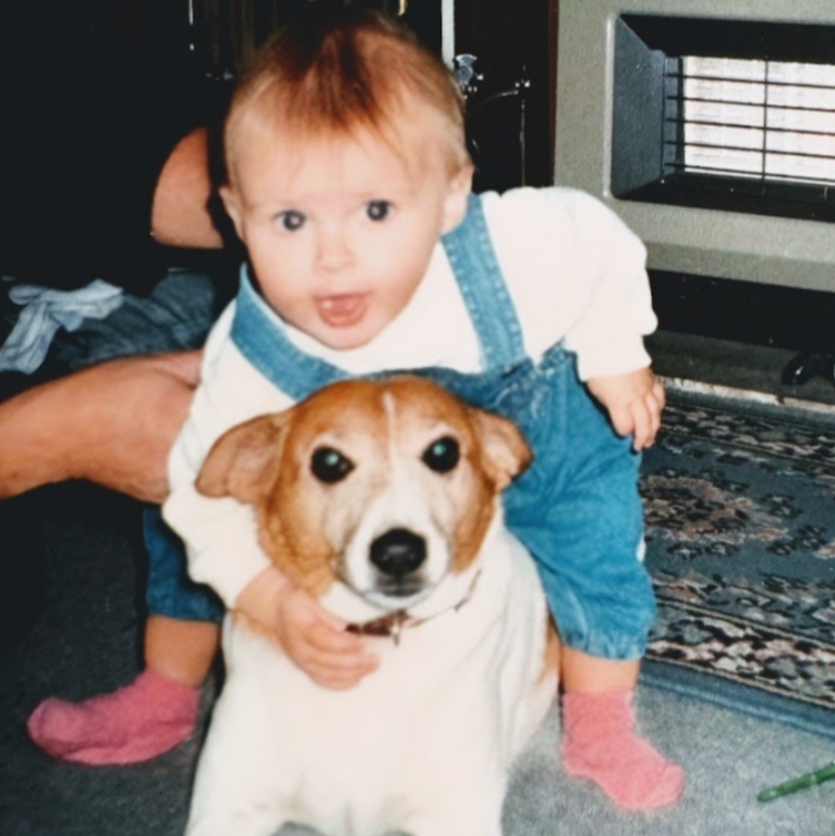 Kay as a baby with a dog. 